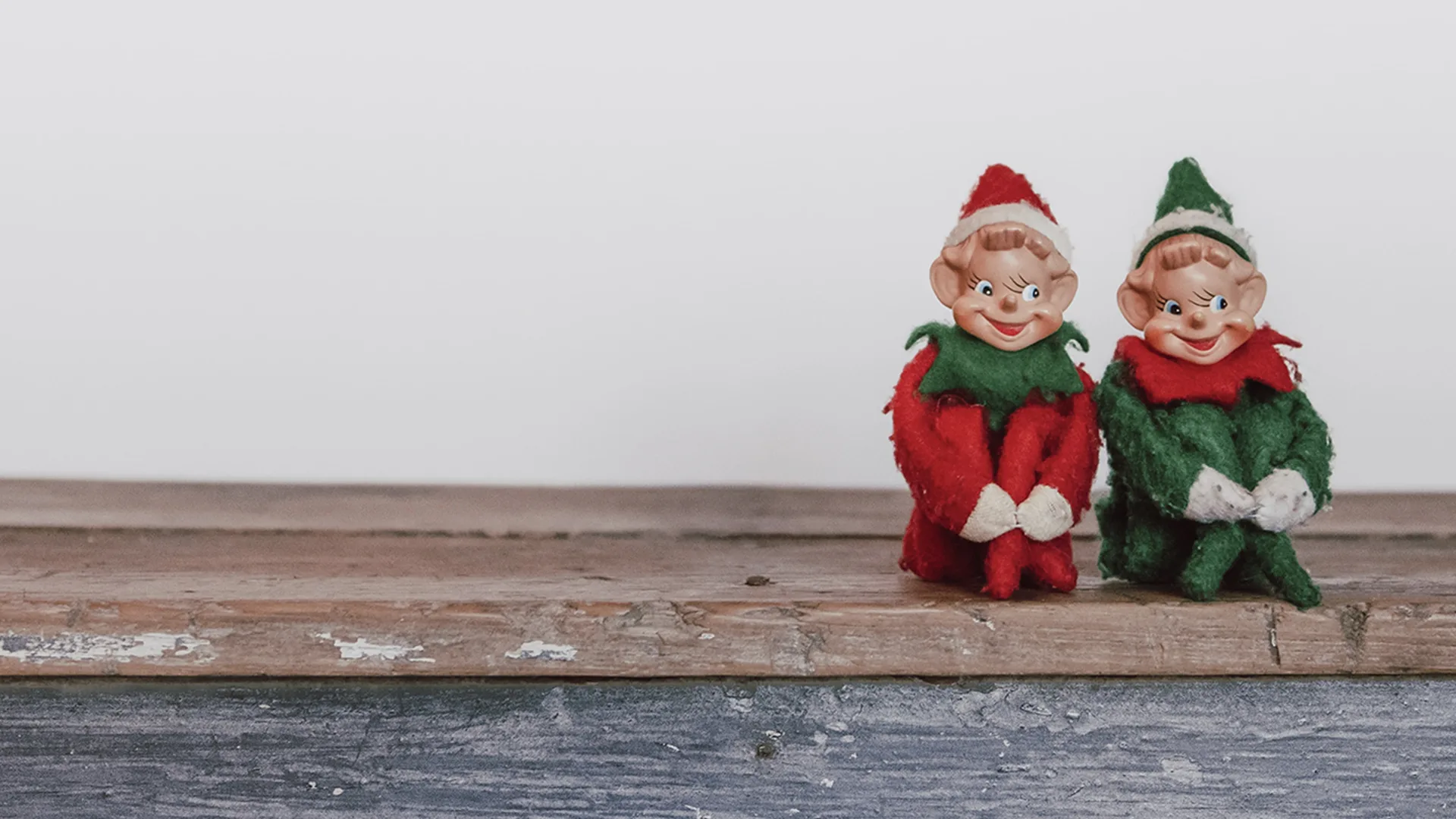Two toy elves sat on a step