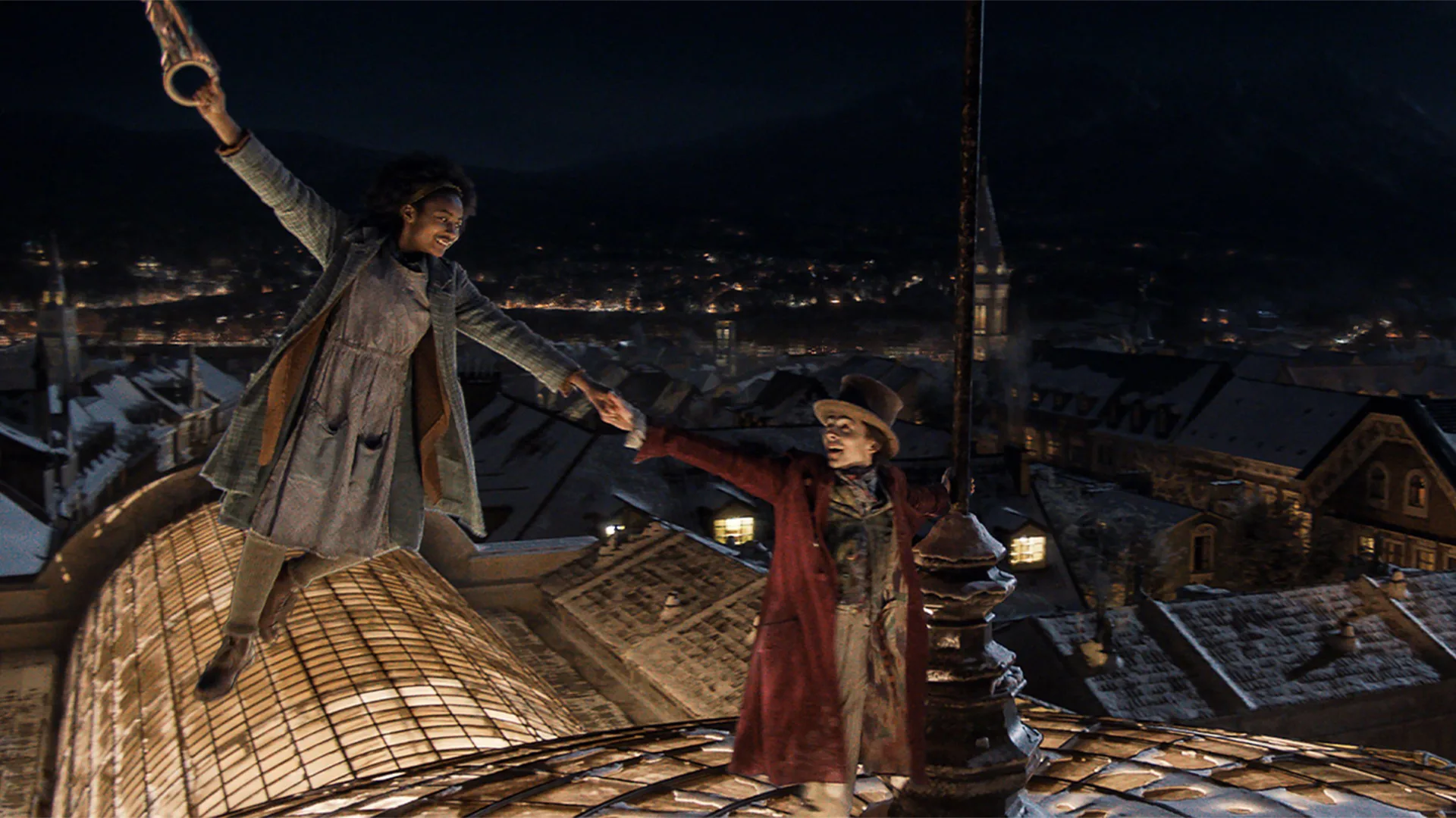 Wonka and girl dancing on rooftops in the movie
