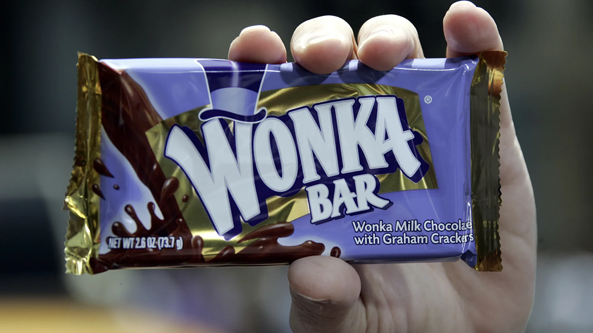 Wonka purple chocolate bar held by someone's hand
