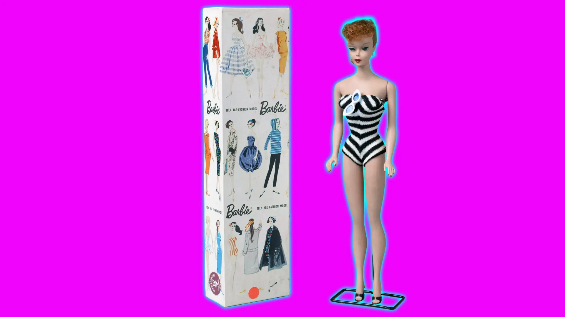 A photo of the original Barbie doll showing her on a black stand wearing a black and white chevron swimsuit with short reddish hair and the box next to her showing different models in 1950s clothing set against a pink background with a blue halo