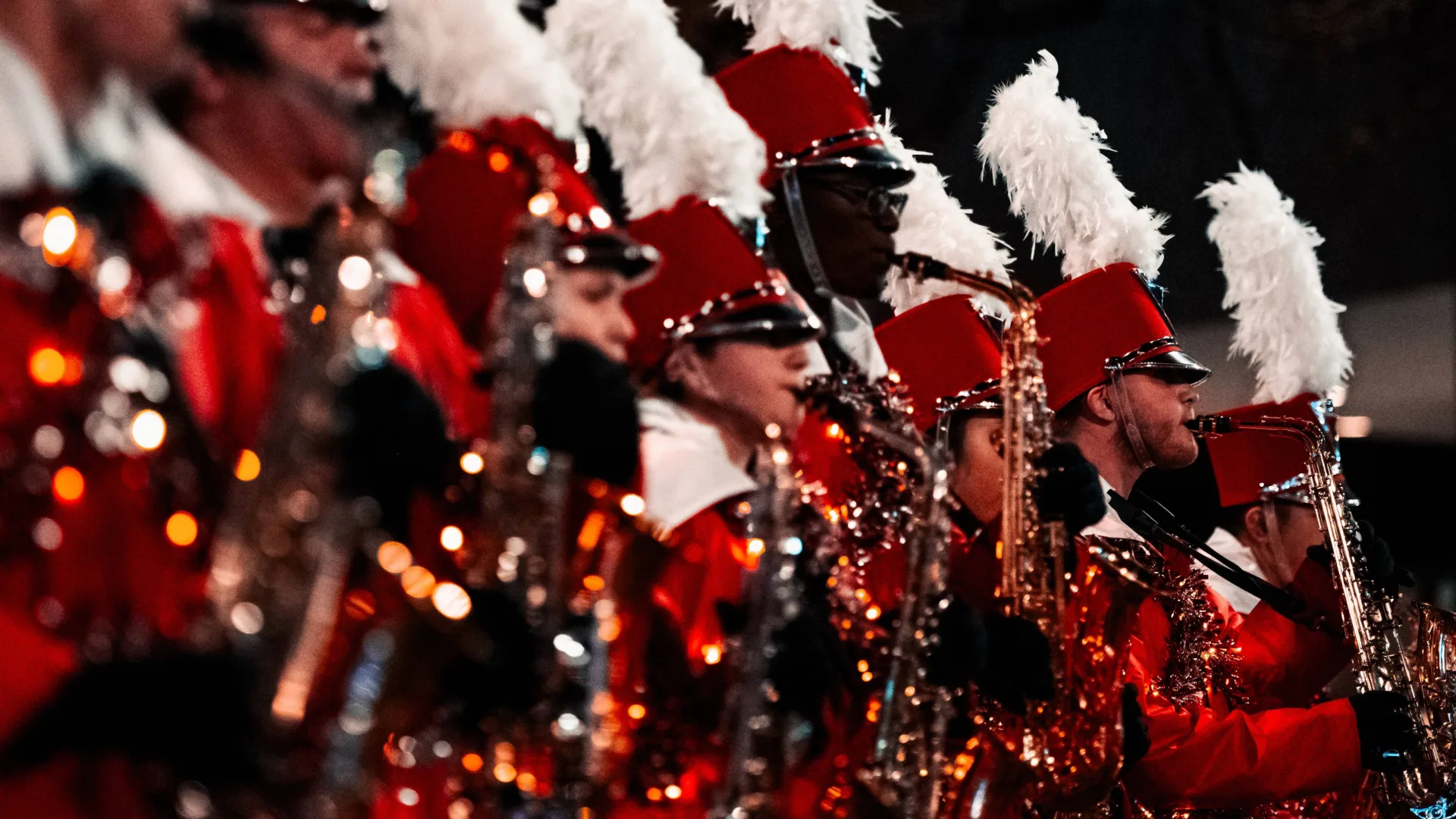 Image of a high school brass band wearing red costumes