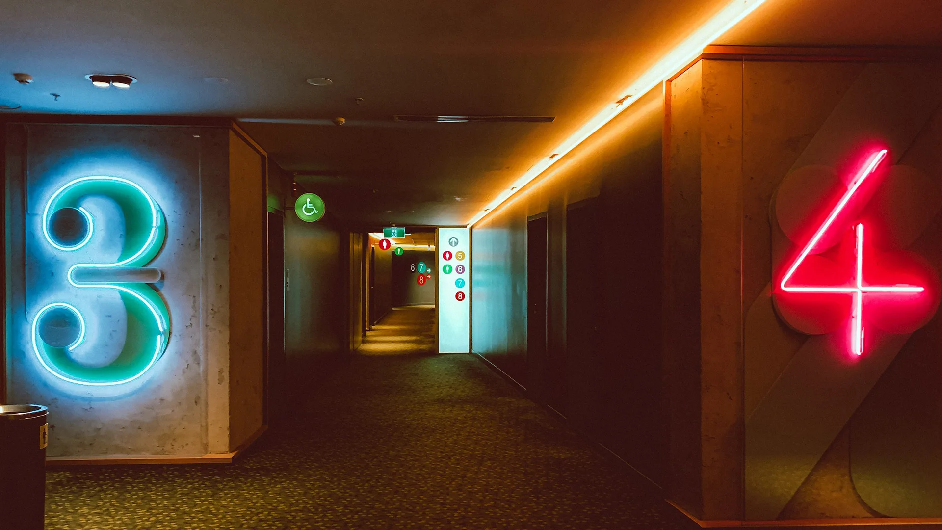 Neon numbers in a dimly lit hotel corridor