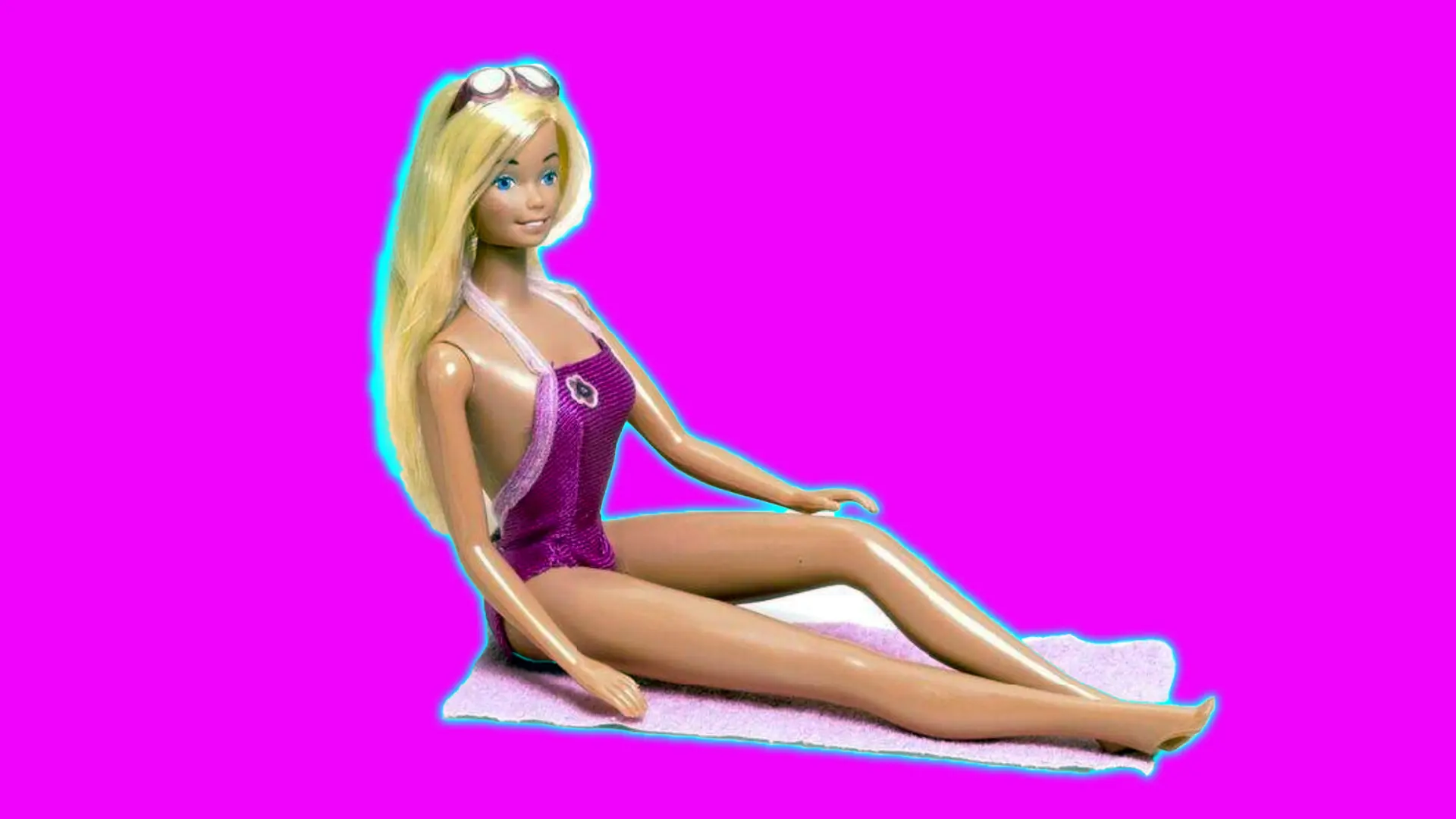 A photo of Malibu Barbie sat on her little white towel wearing a pink swimsuit against a pink background with a blue halo.