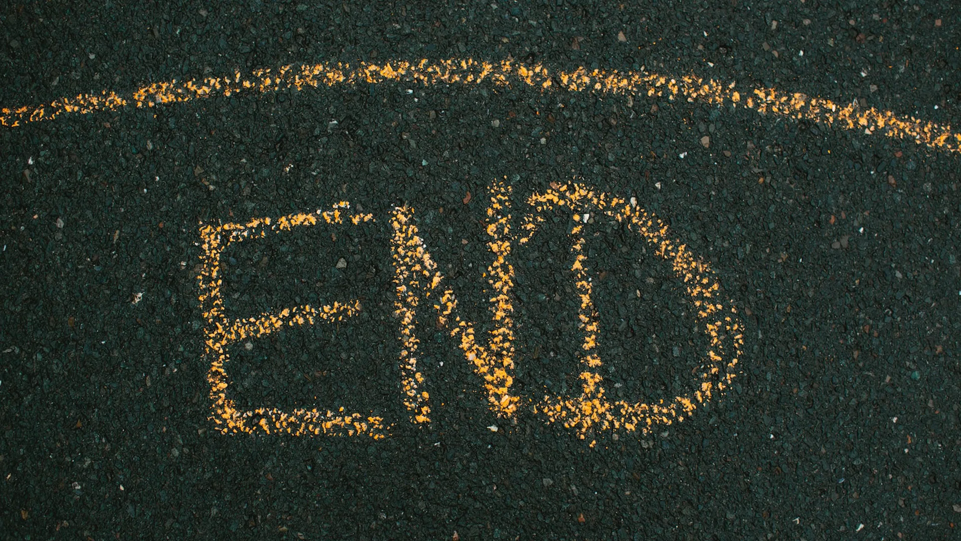 The END written in yellow on a dark coloured floor
