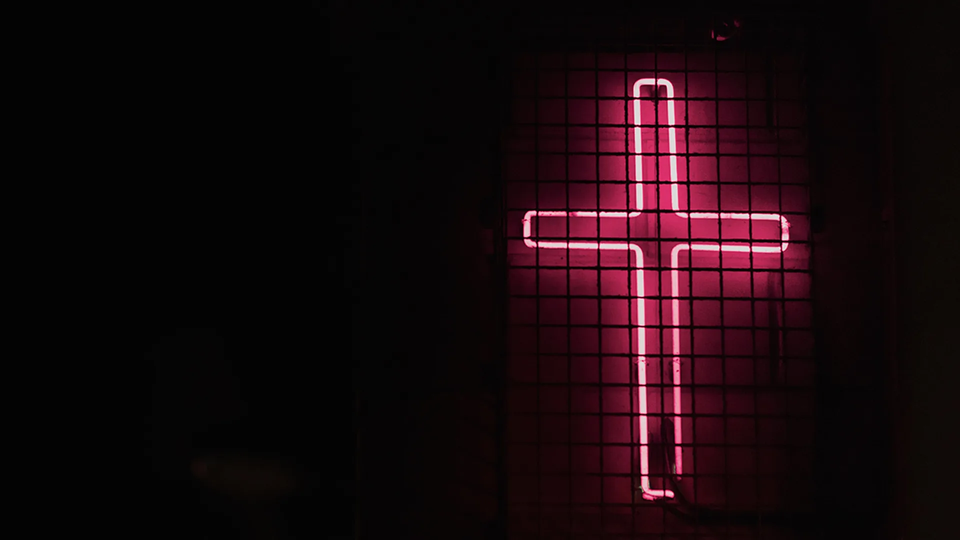 A pink cross in neon lights