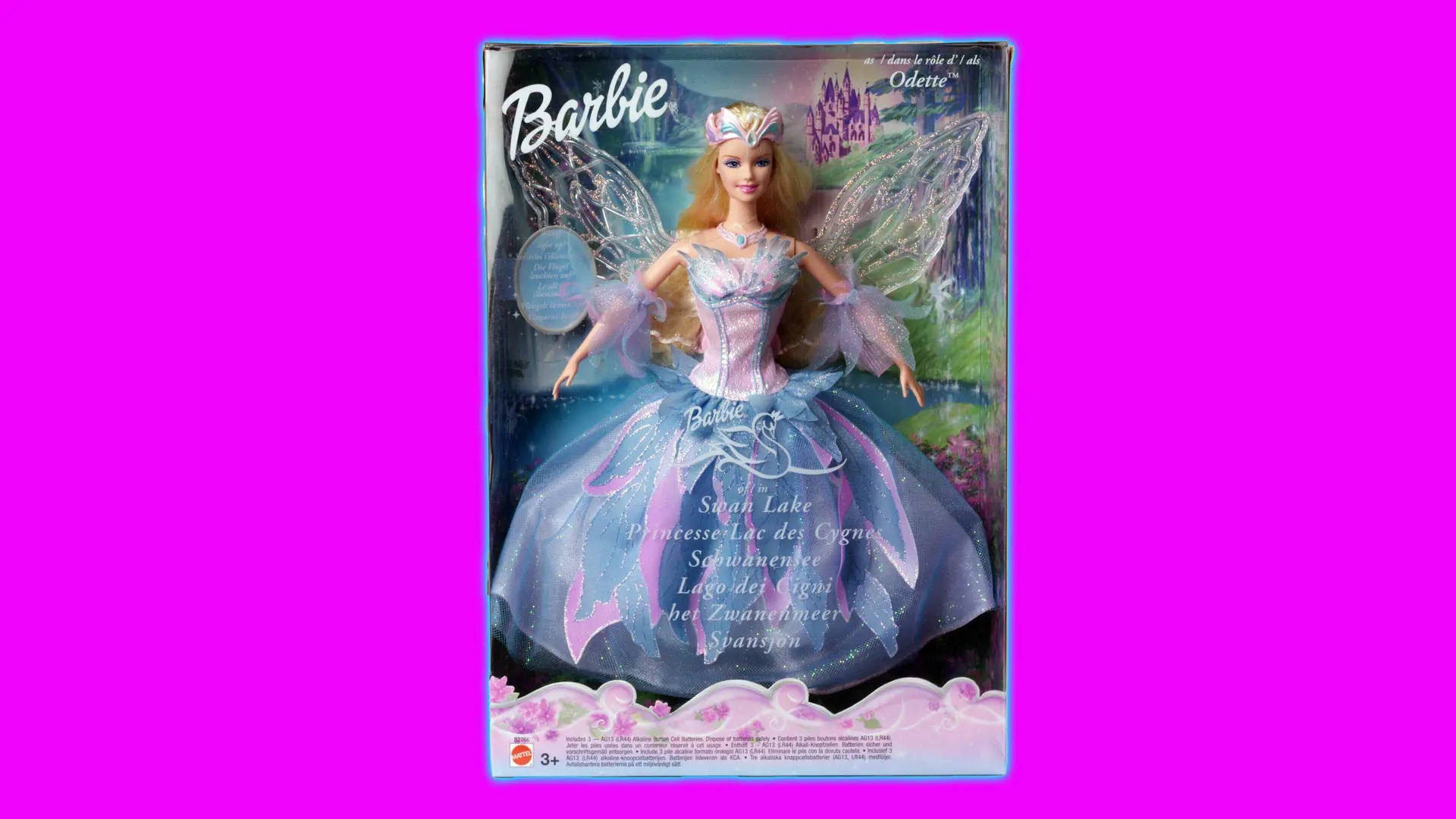 A photo of Swan Lake Barbie in her box wearing a pink and blue iridescent gown sporting wings set against a pink background with a blue halo.