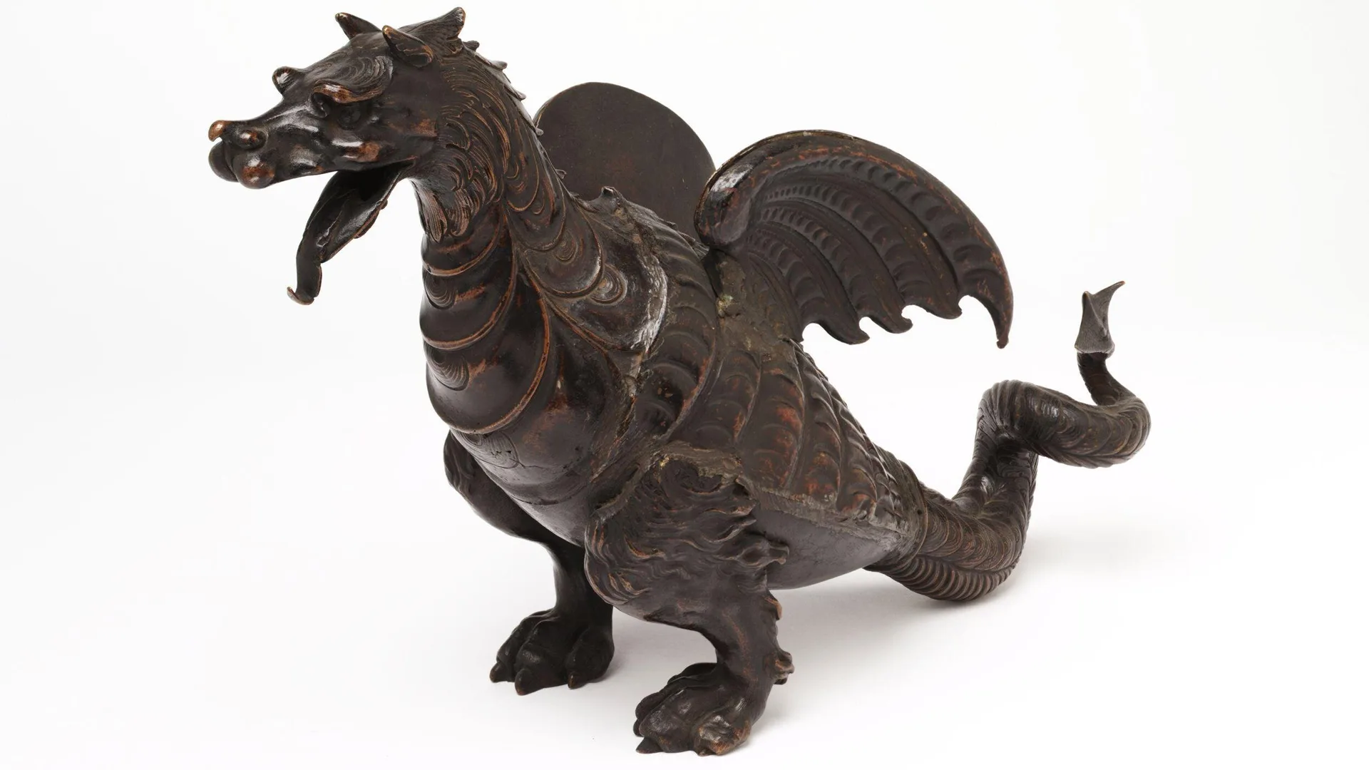 Photograph of a bronze winged dragon statue