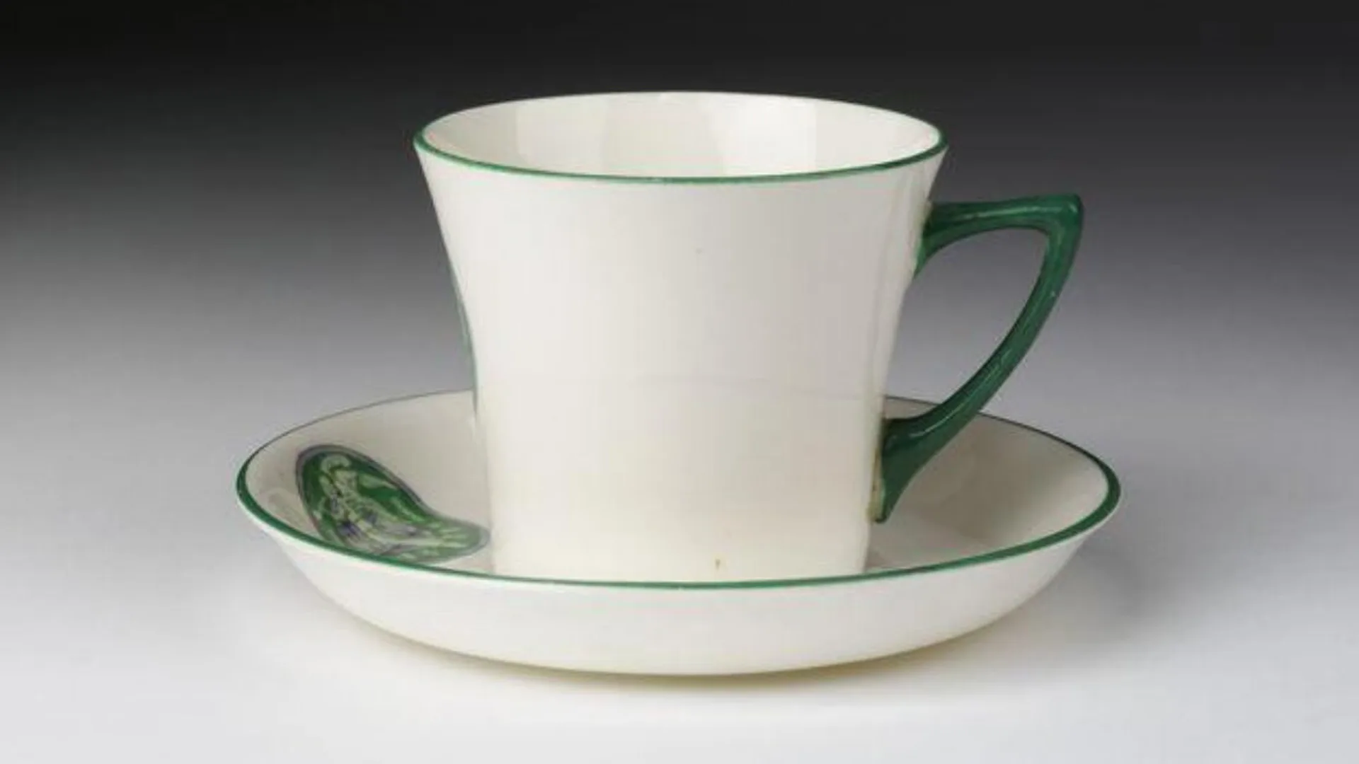 A photograph of a teacup and saucer designed by Sylvia Pankhurst