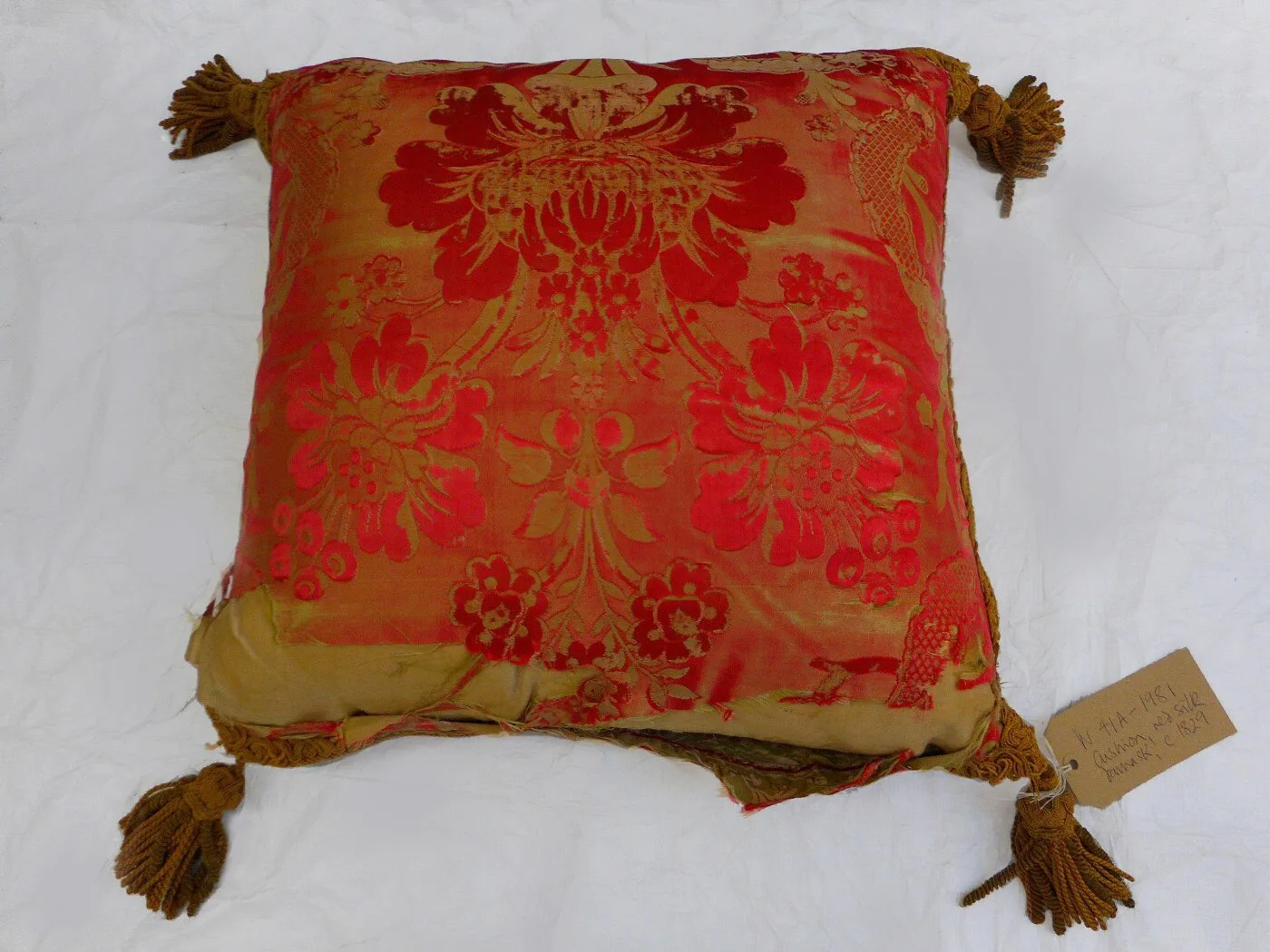 A red and gold cushion