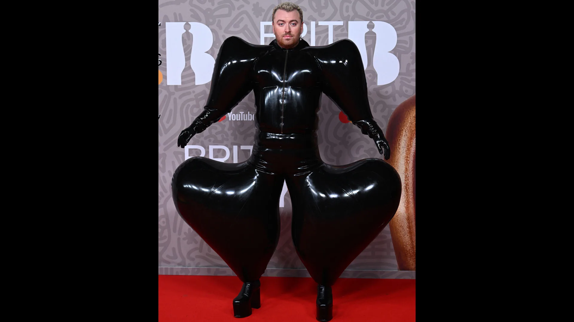 Photograph of Sam Smith in an inflatable black jumpsuit
