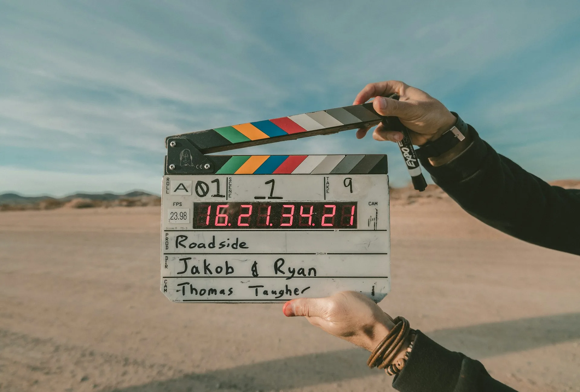 Hands holding up a film clapperboard