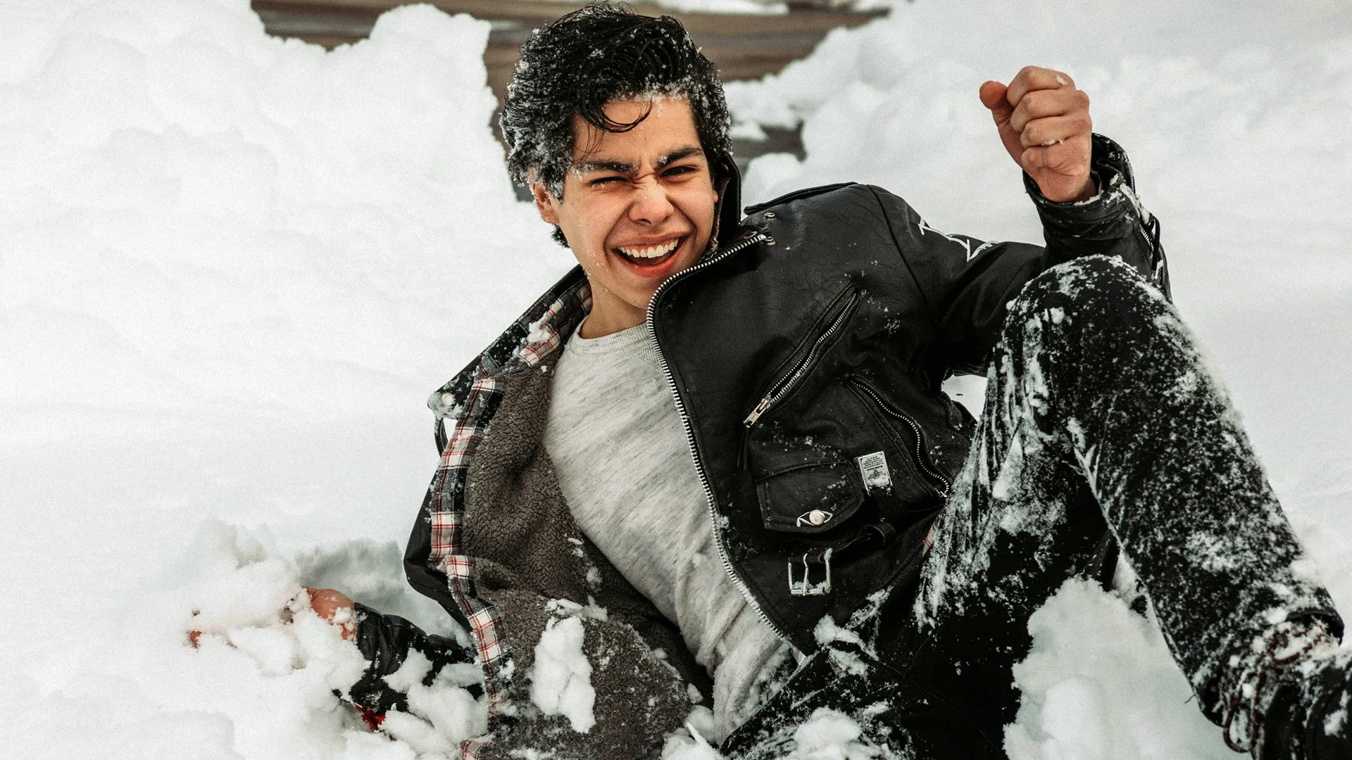 Photograph of a man laughing in the snow