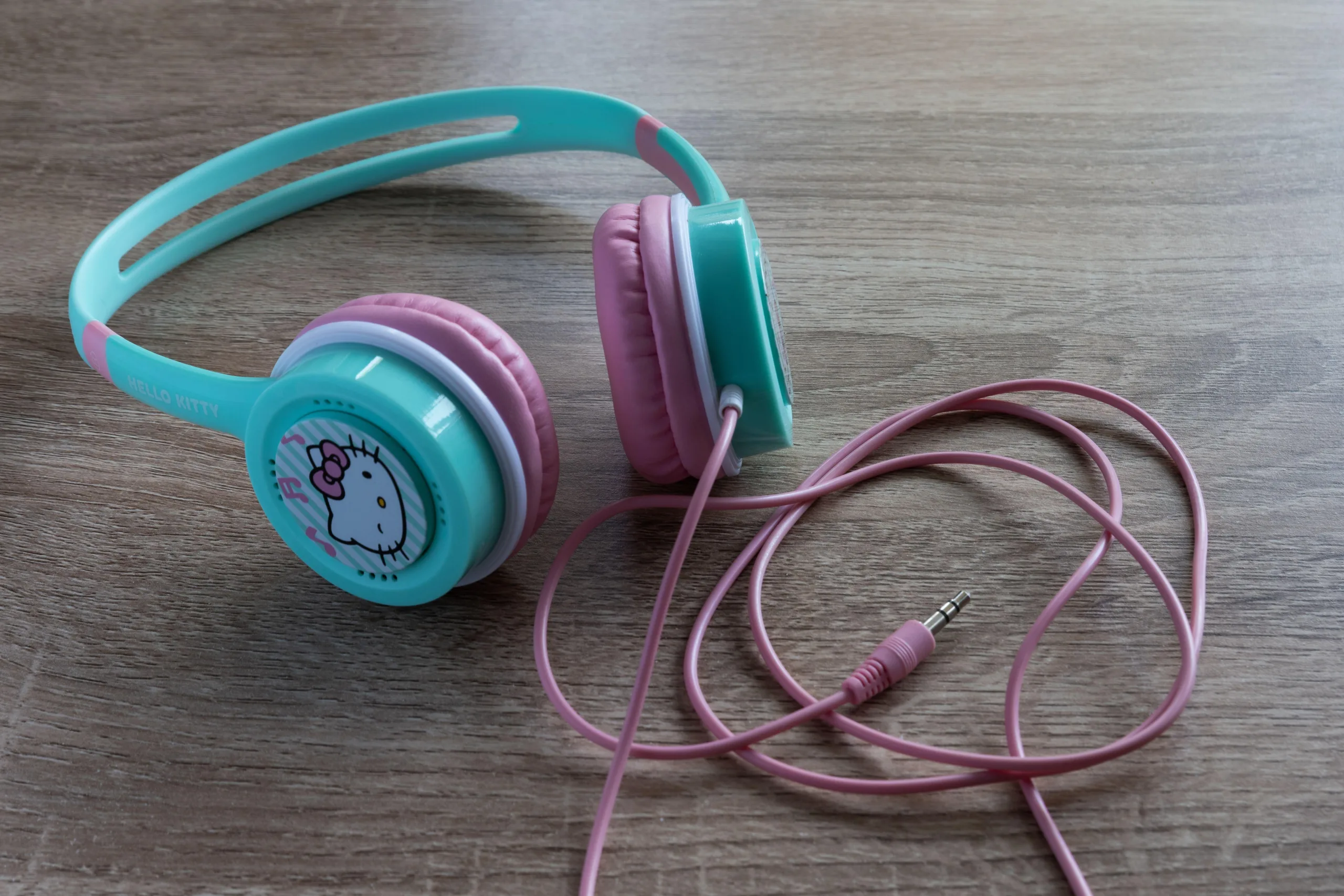 Blue and pink headphones with Hello Kitty logo