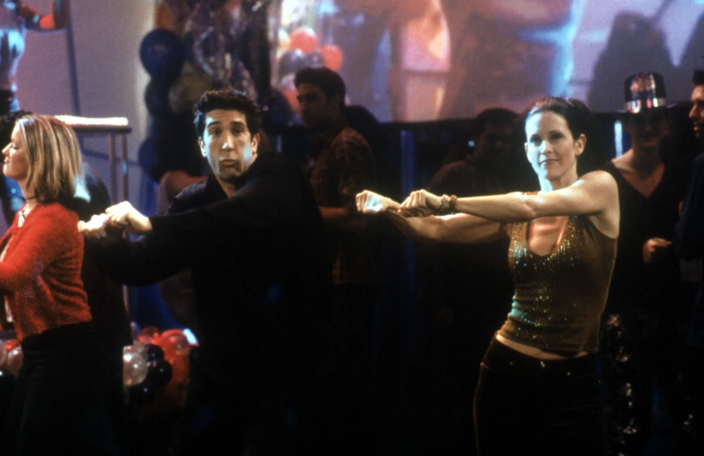 A still from the TV series Friends with Ross and Monica doing a dance