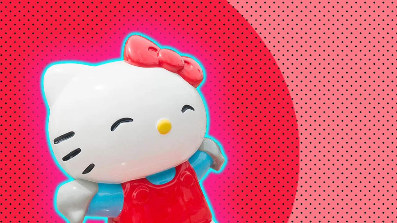 Plastic figure of Hello Kitty against a spotty pink and red background