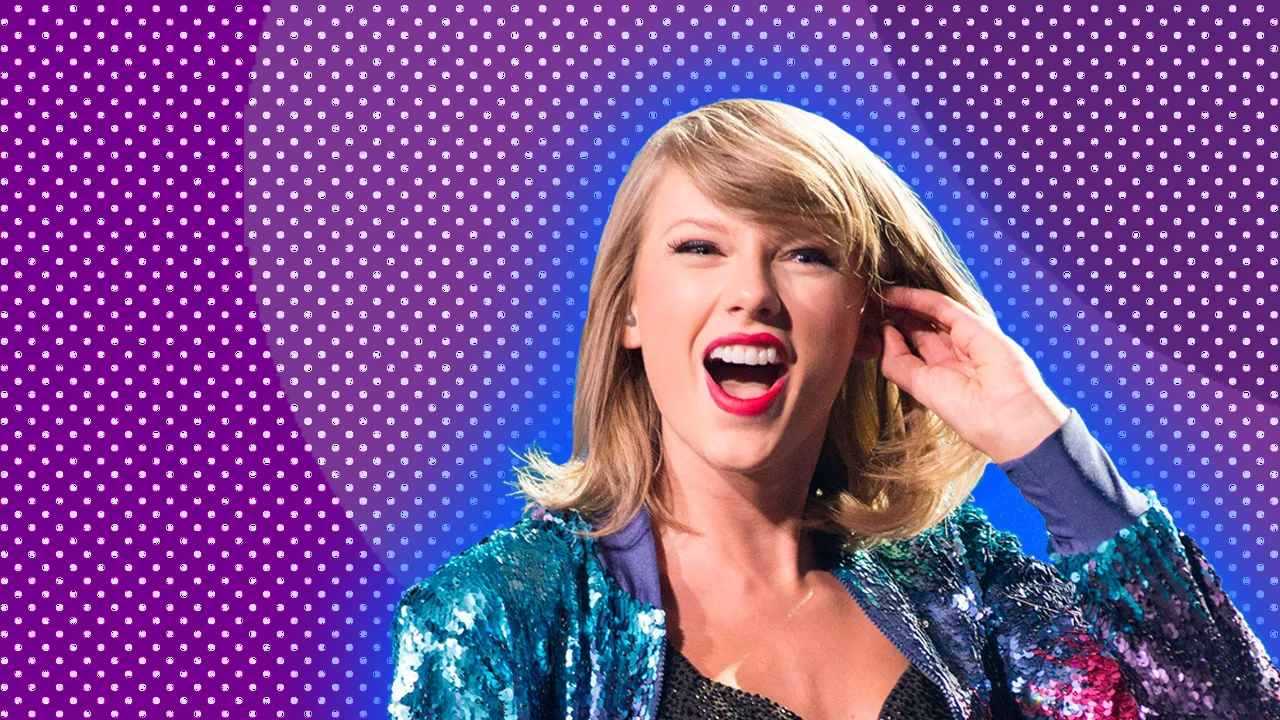 Taylor Swift smiling against a purple background and wearing a sequinned jacket