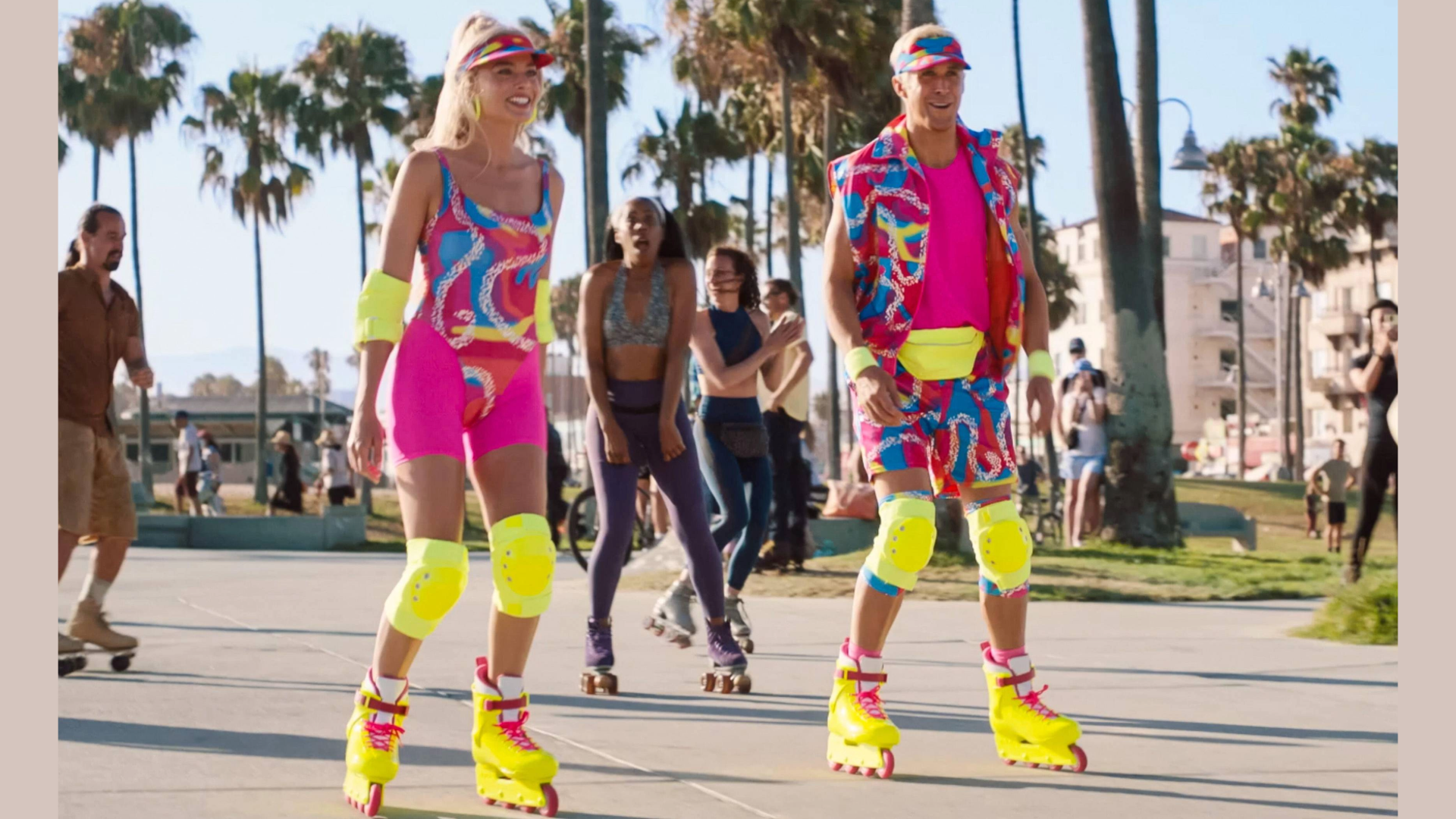 Margot Robbie and Ryan Gosling as Barbie and Ken from the film Barbie both dressing in bright colourful rollerblading outfits skating down a path in LA with palm trees and people behind them