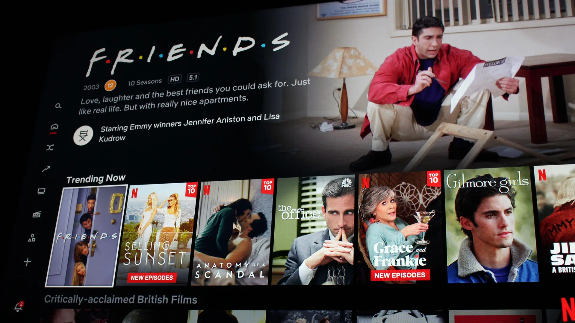 A photo of a TV screen showing Netflix menu including Friends