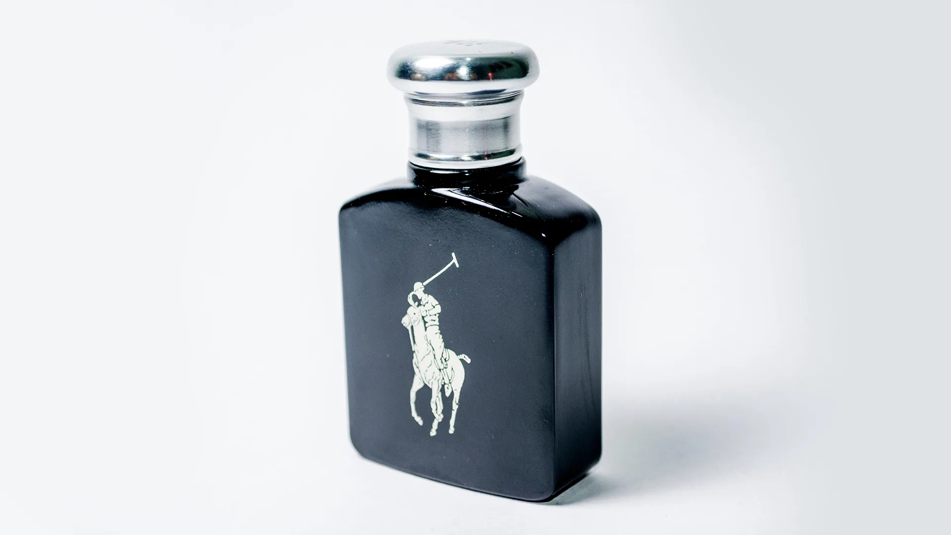 Bottle of Ralph Lauren Polo cologne against a grey background