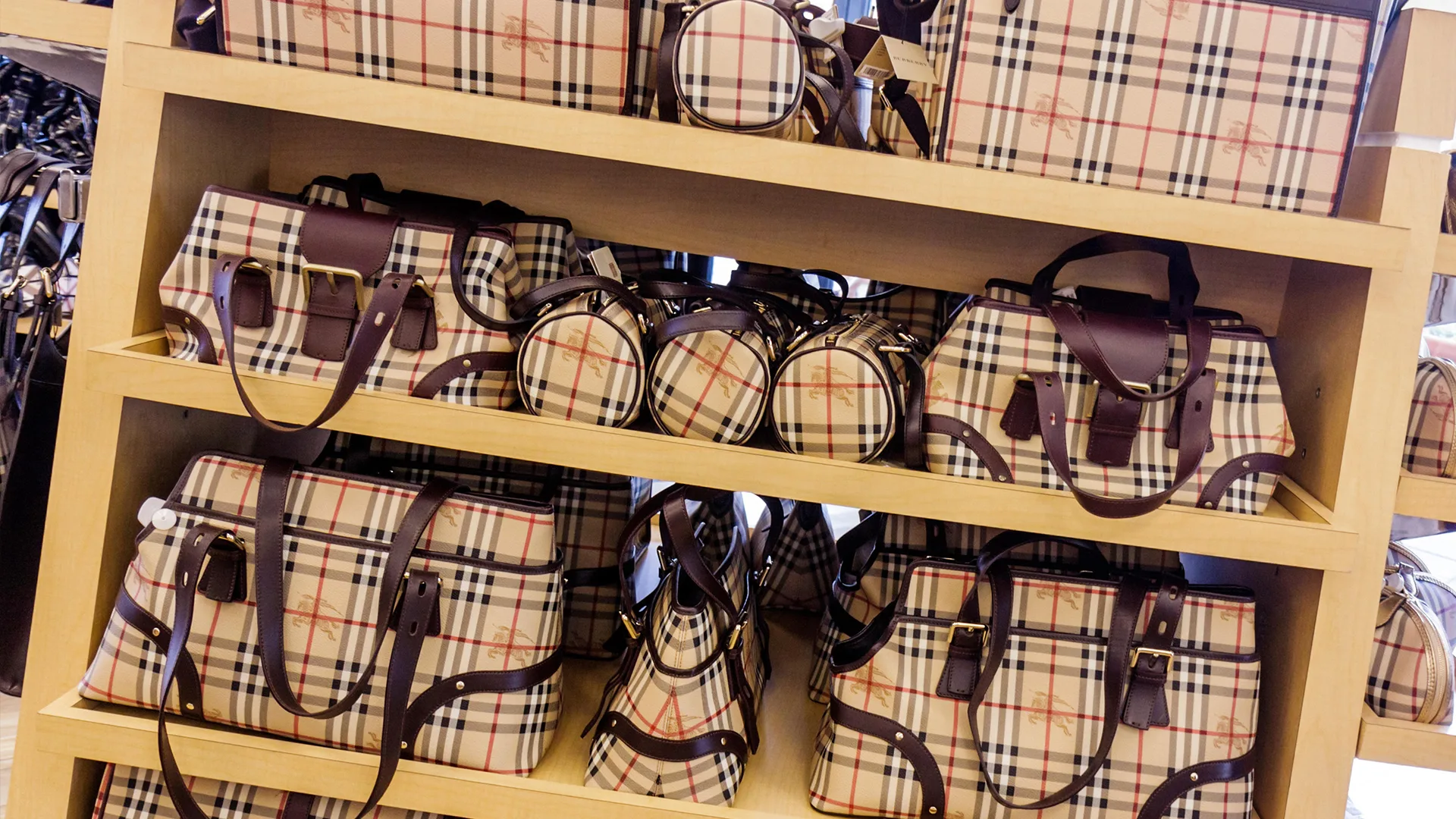 Burberry bags on wooden shelves