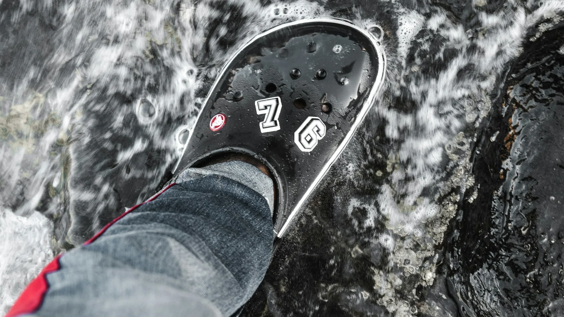 Black croc on watery surface with jibbitz on 