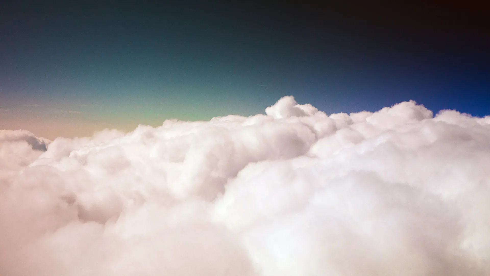 A photograph of fluffy white clouds against a blue sky