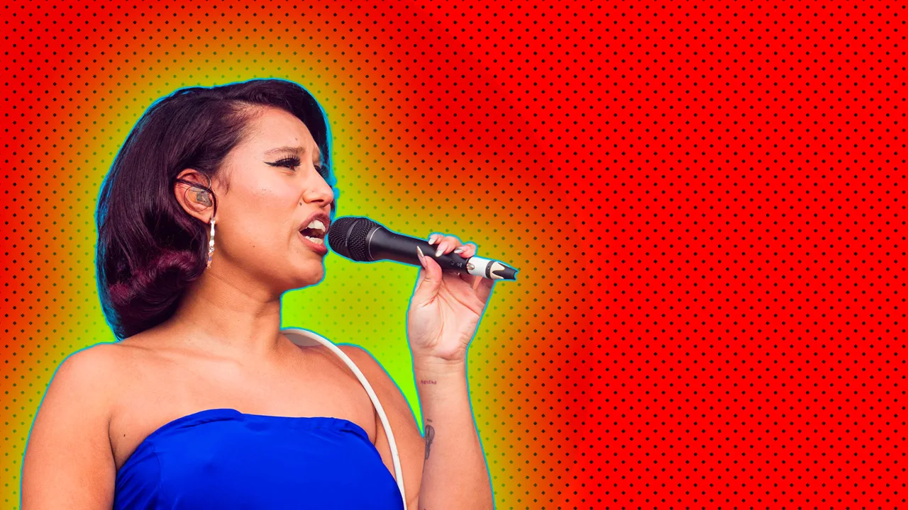 A photograph of Raye singing into a microphone wearing a blue strapless top with a white lead over her shoulder. She is against a red and black spotted background with a yellow green halo.
