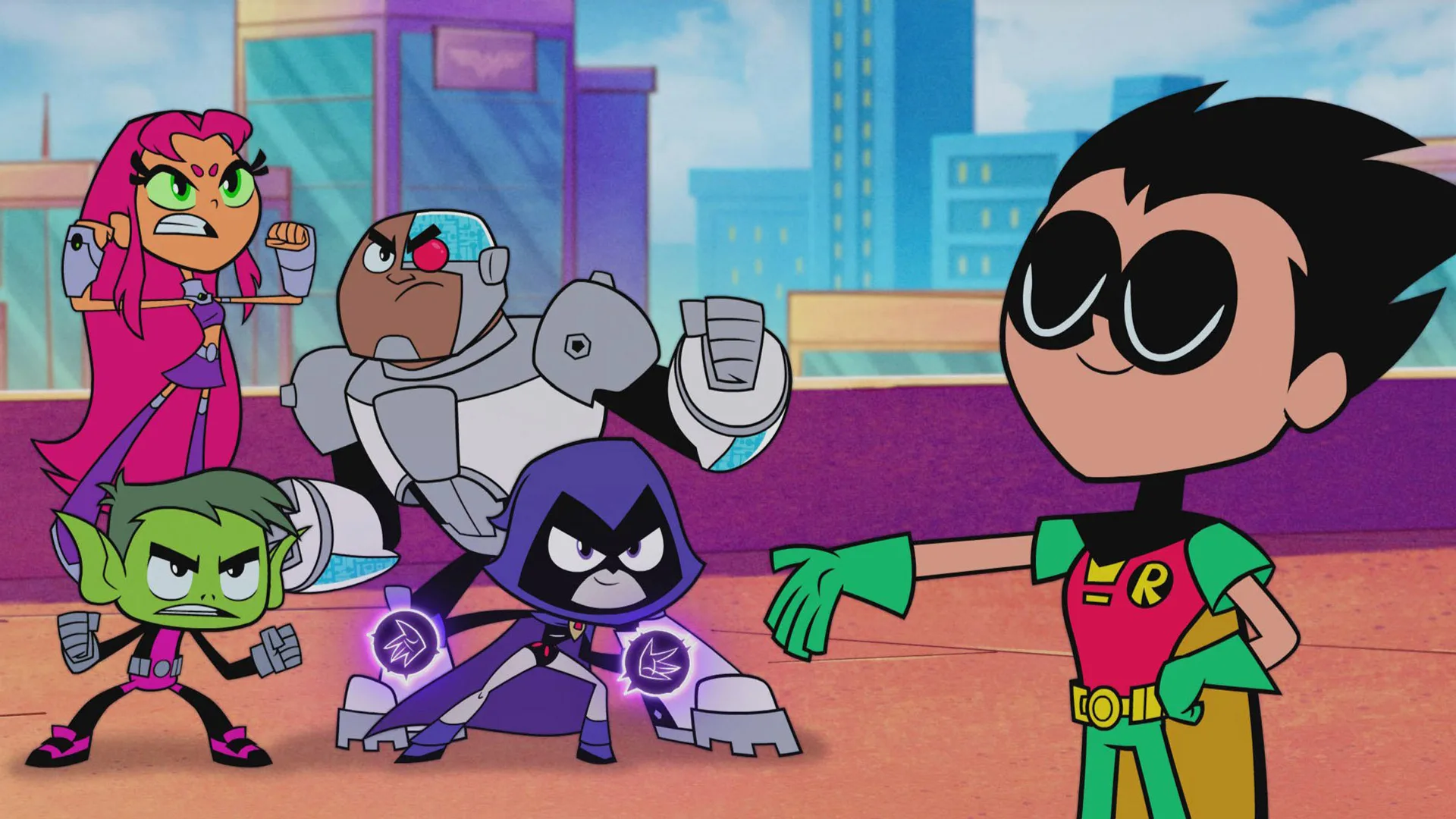 A still from the cartoon Teen Titans Go showing the characters all looking ready for battle in different fighting poses against a skyscraper background.