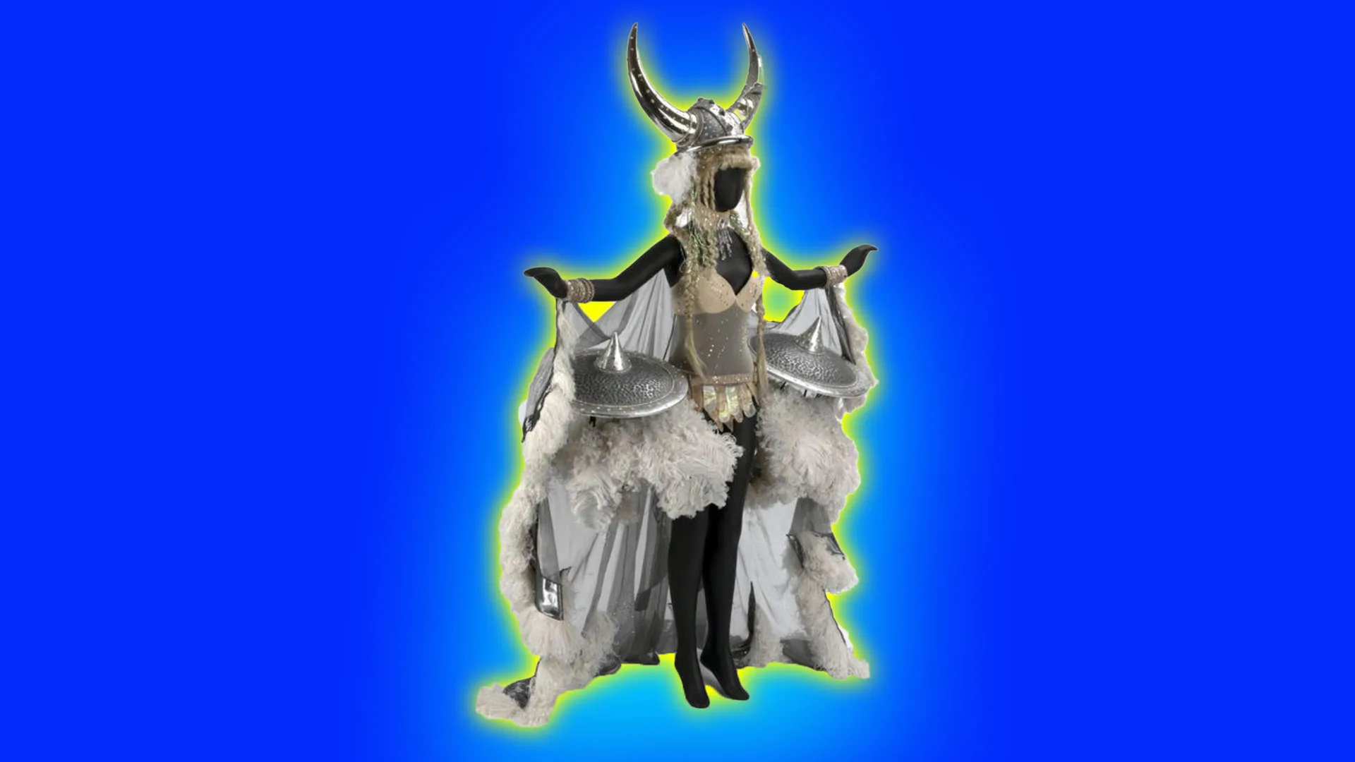 An image of a theatre costume showing a mannequin wearing a silver feathered viking outfit with horned hat and arms outstretched displaying the white feathers. It is set against a blue background with a blue halo.