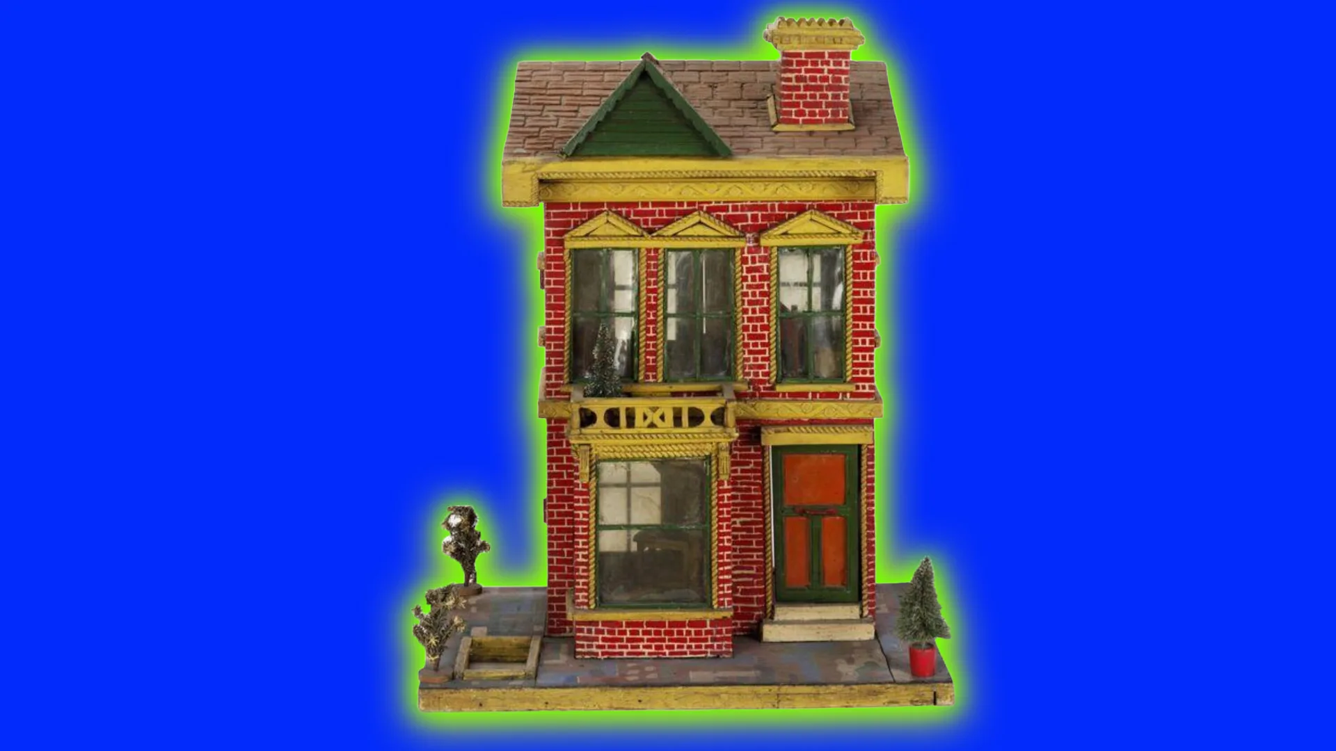 An image of a 1940s wooden dollhouse with two floors, red bricks and yellow shutters above the windows with a little path and trees beside it. The house is set against a cobalt blue background with a green halo.