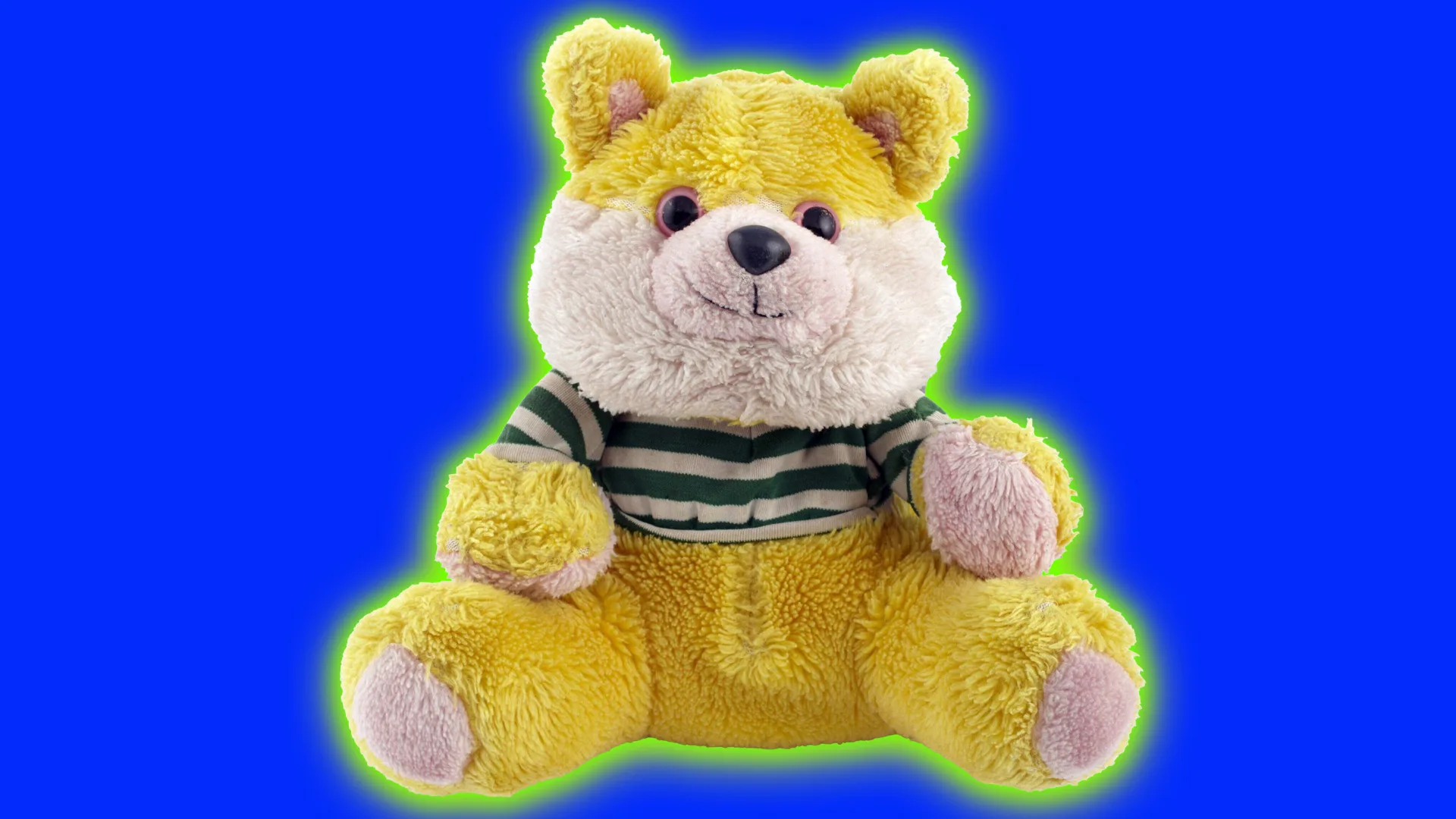 An image of a WereBear in it's cute form with yellow fur and a stripey top. It is set against a cobalt blue background with a green halo.