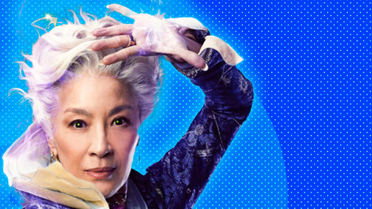 An image of Michelle Yeo from Wicked holding her hand to her head looking directly at the viewer.