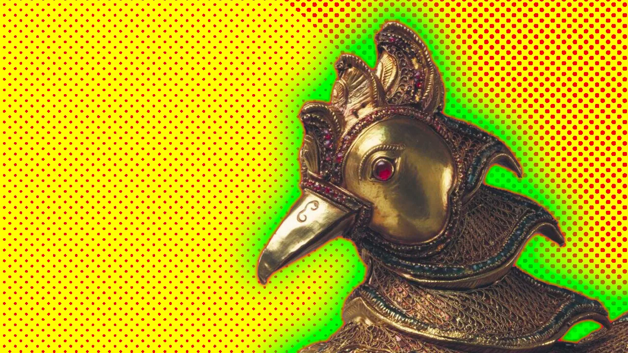A photo of a bronze bird with a red gem for an eye set against a yellow dotted background with a green halo.