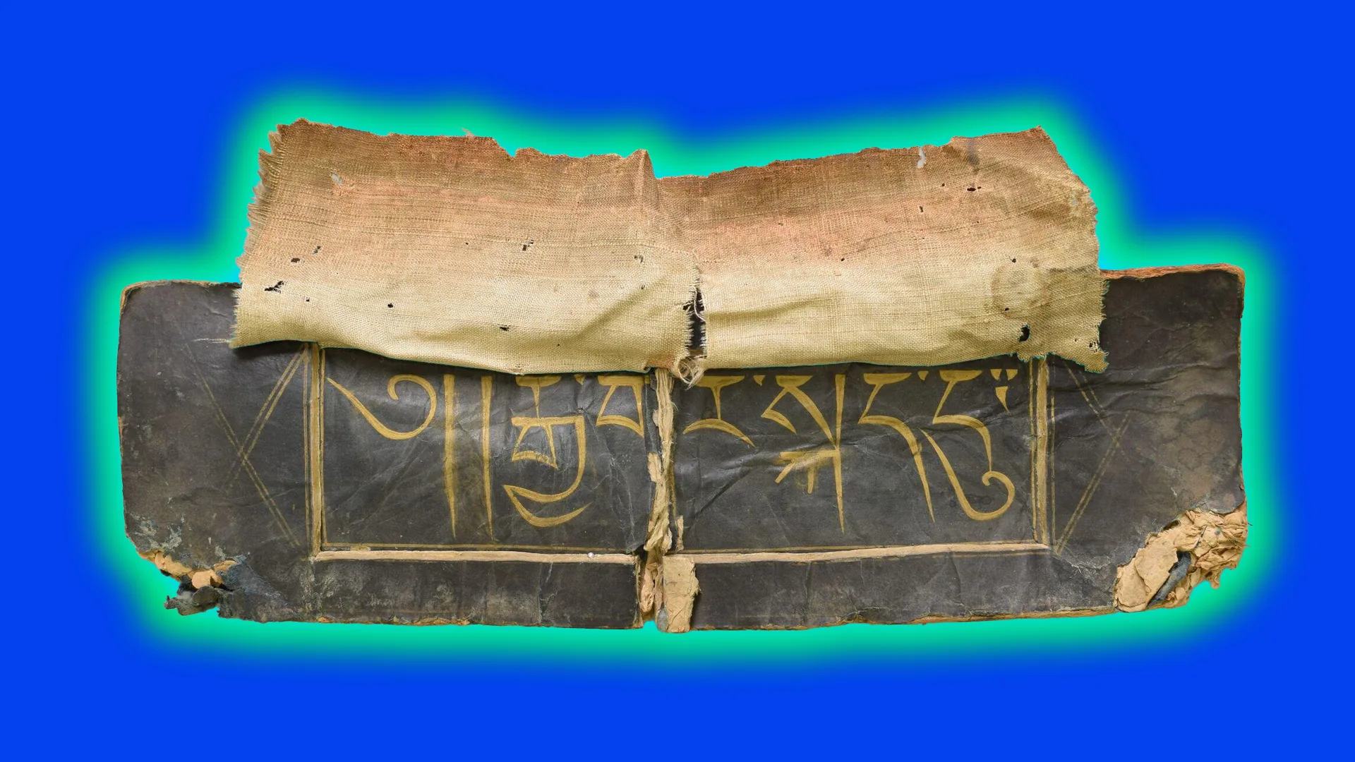 A photograph of some brown paper with Tibetan inscriptions in gold. It is set against a blue background with a green halo.