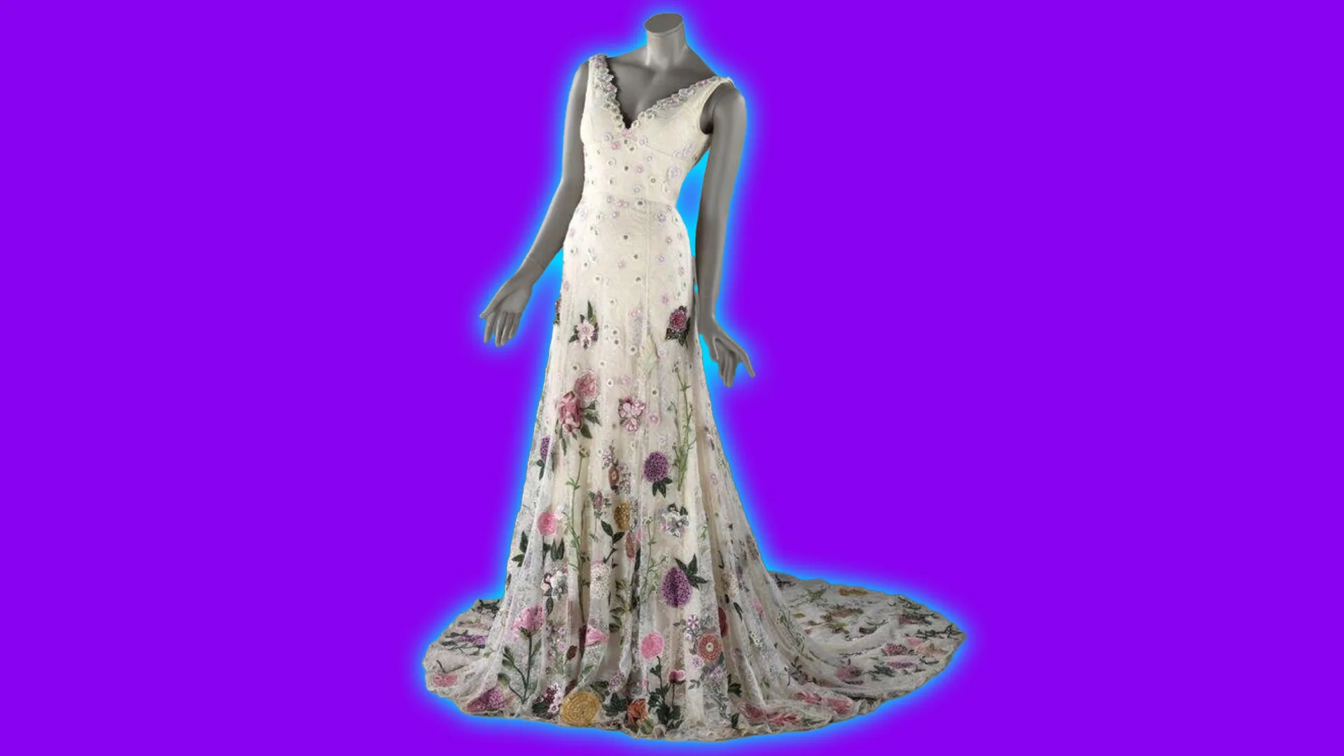 An image of a 2018 wedding dress in floral lace with a train. It is set against a purple background with a blue halo.