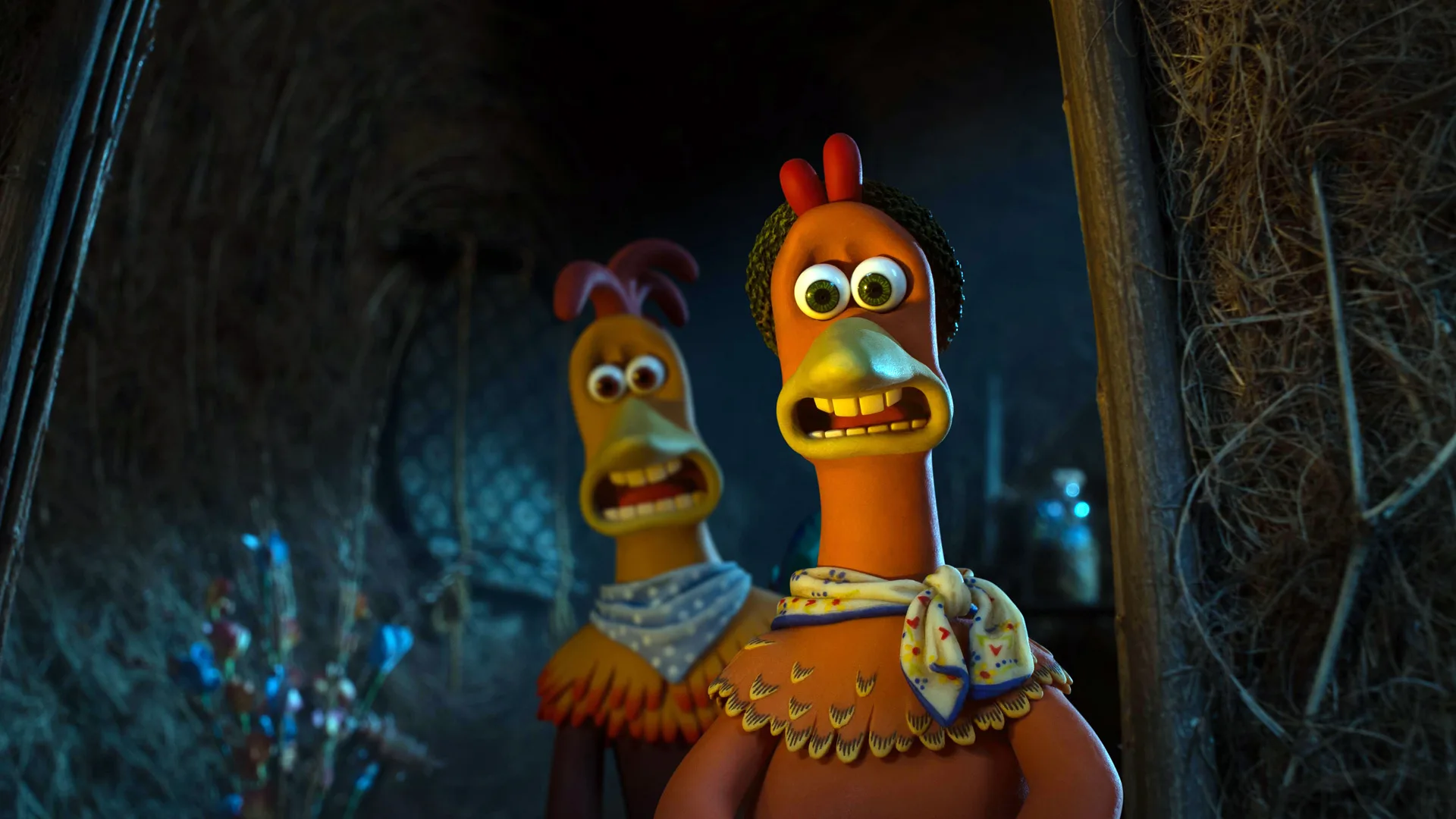 A still from Chicken Run showing Rocky and Ginger with scared looks on their faces in a dark place.