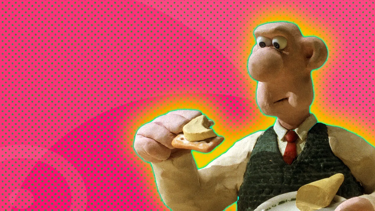 An image of Wallace from A Grand Day Out eating cheese on a cracker set against a pink dotted background with a yellow halo.