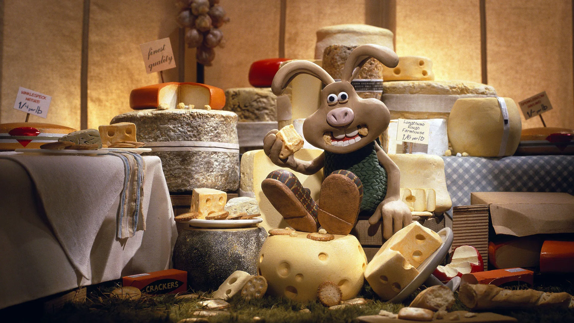 A still from The Curse of the Were-Rabbit showing a rabbit wearing a green sweater sat on a pile of cheese eating cheese.