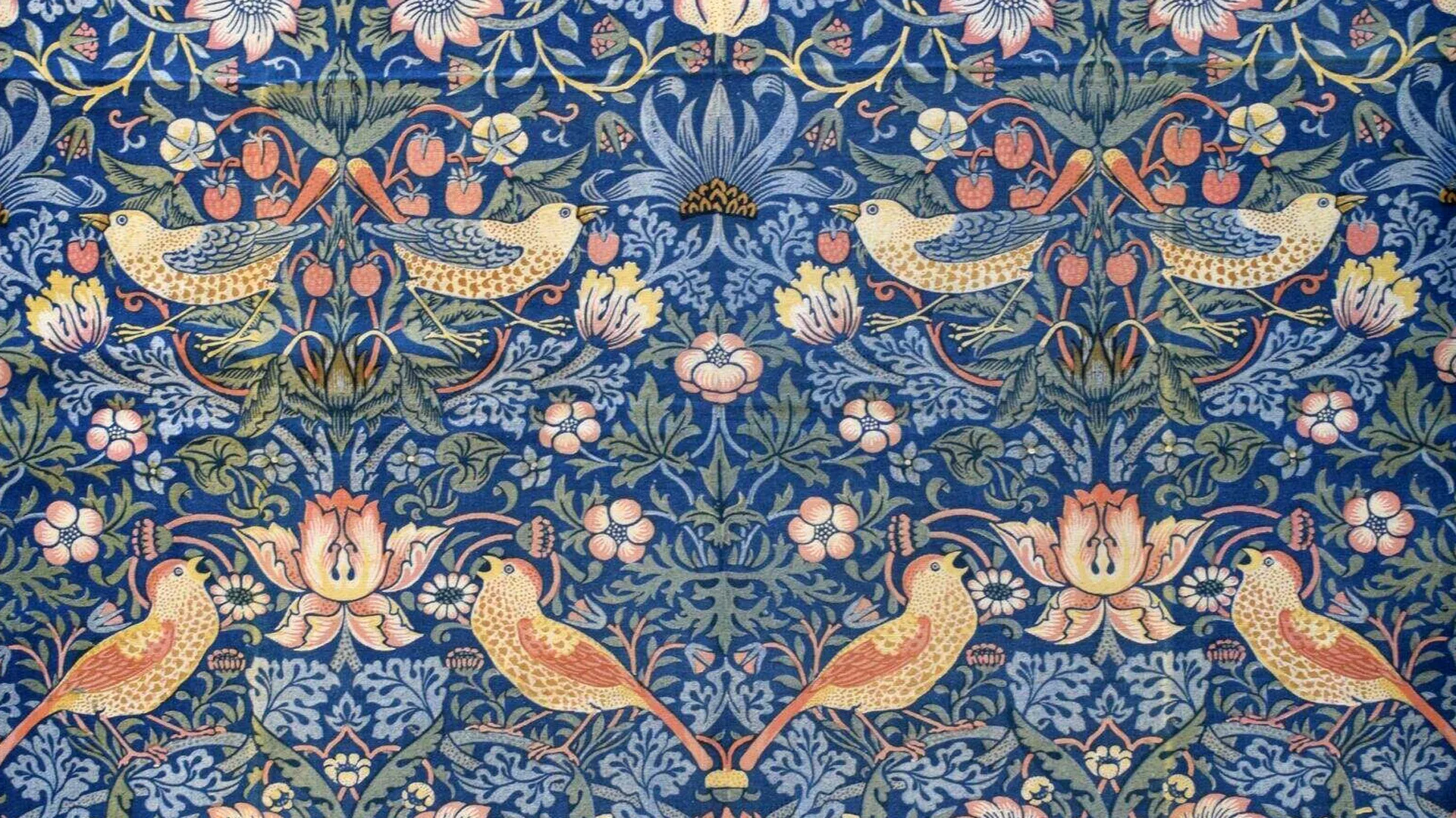 A pattern of William Morris showing flowers and thrushes with little strawberries in colours of blues, greens, yellows, pinks and reds.