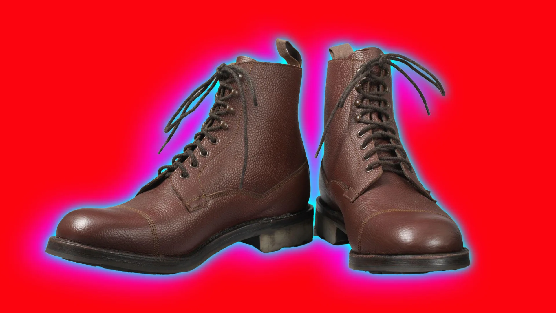 A photo of a pair of brown laced up ankle boots set against a red background with a blue and pink halo
