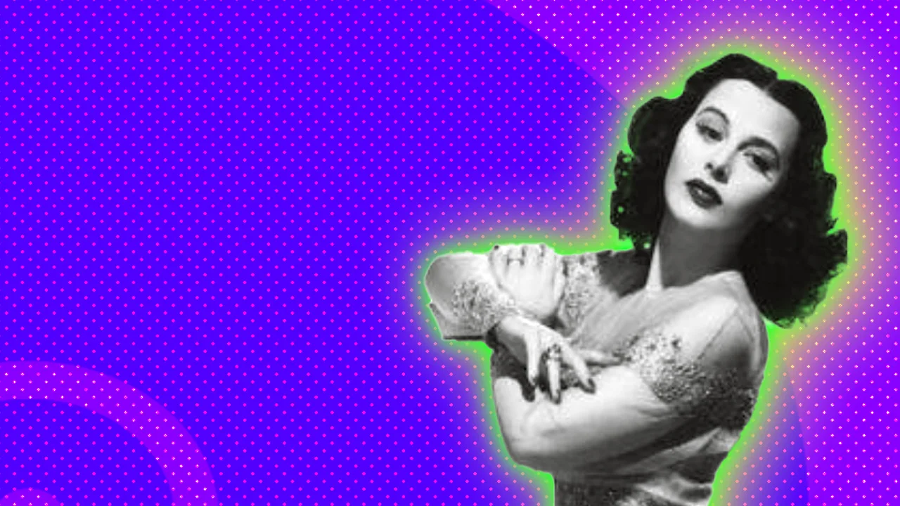 A black and white photograph of Hedy Lamarr stood in long gown with her arms crossed looking over her shoulder - she is set against a purple dotted background with a green halo.