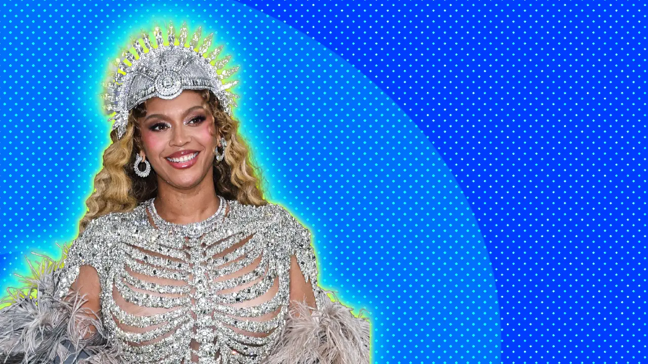 A photo of Beyonce at Met Gala 2026 wearing a diamante skeleton like outfit with a crown set against a blue dotted background.