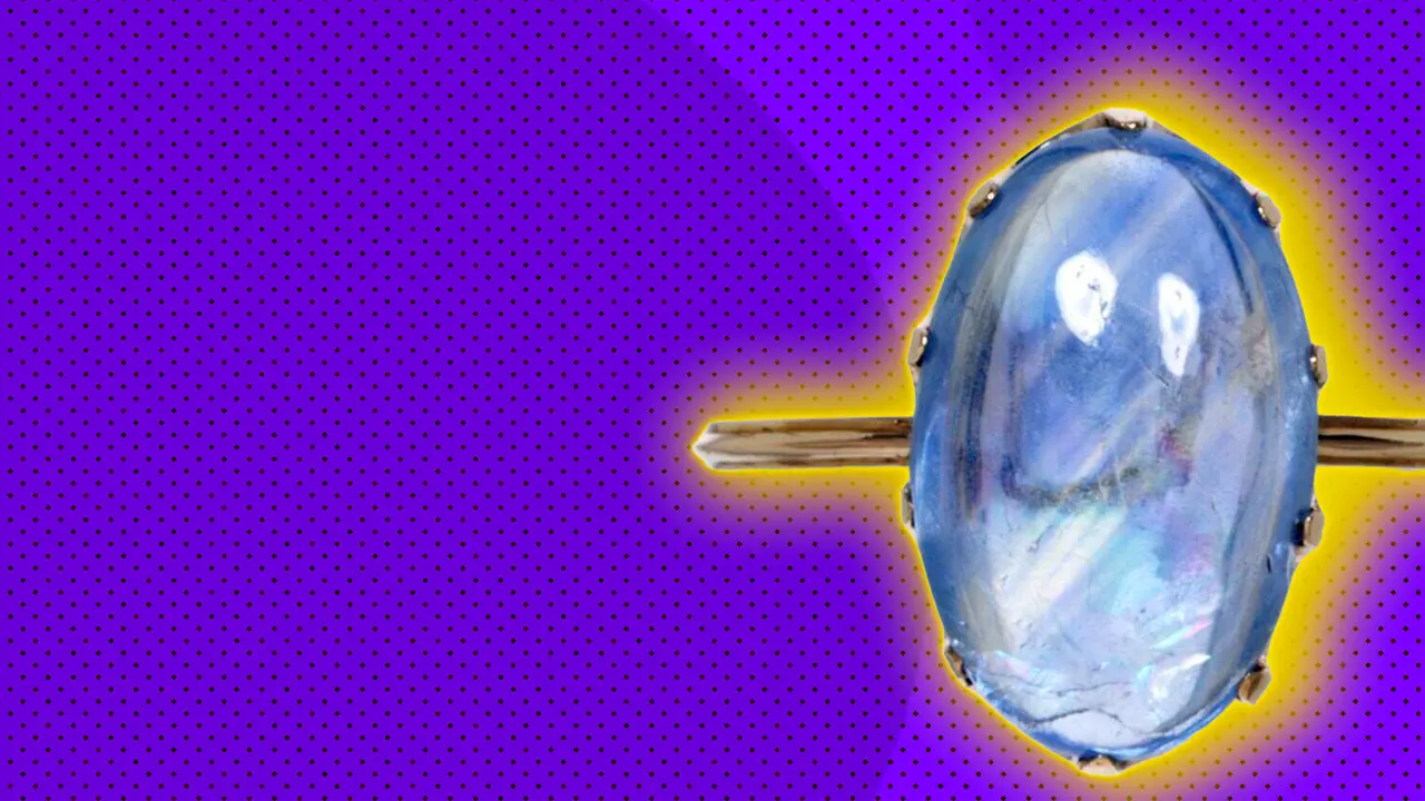 An image of a purple ring with a gold band set against a purple background with a yellow halo.
