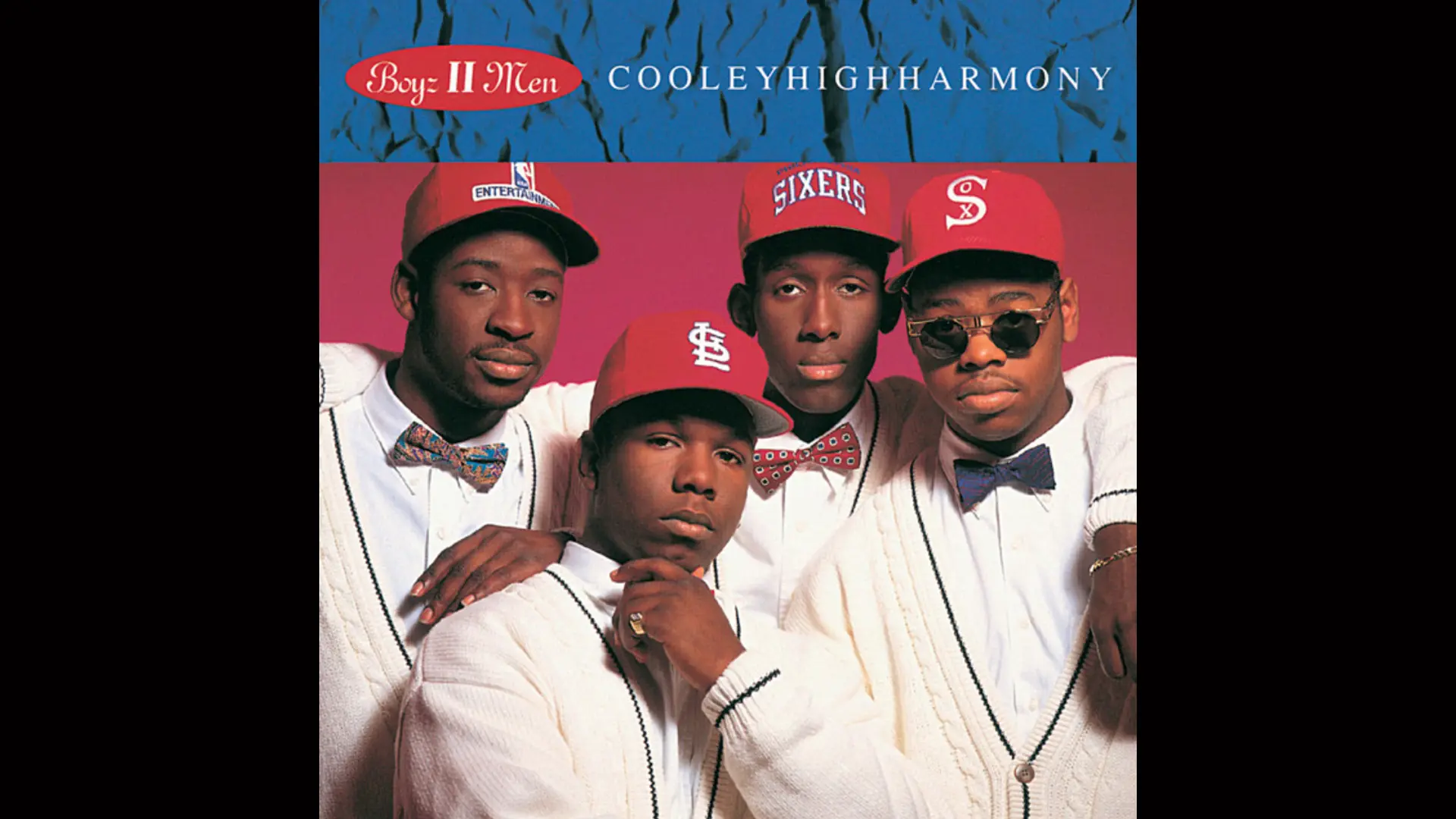 The album cover Cooleyhighharmony by Boyz II Men showing the four band members wearing red caps and white shirts and cardigans against a red and blue background.