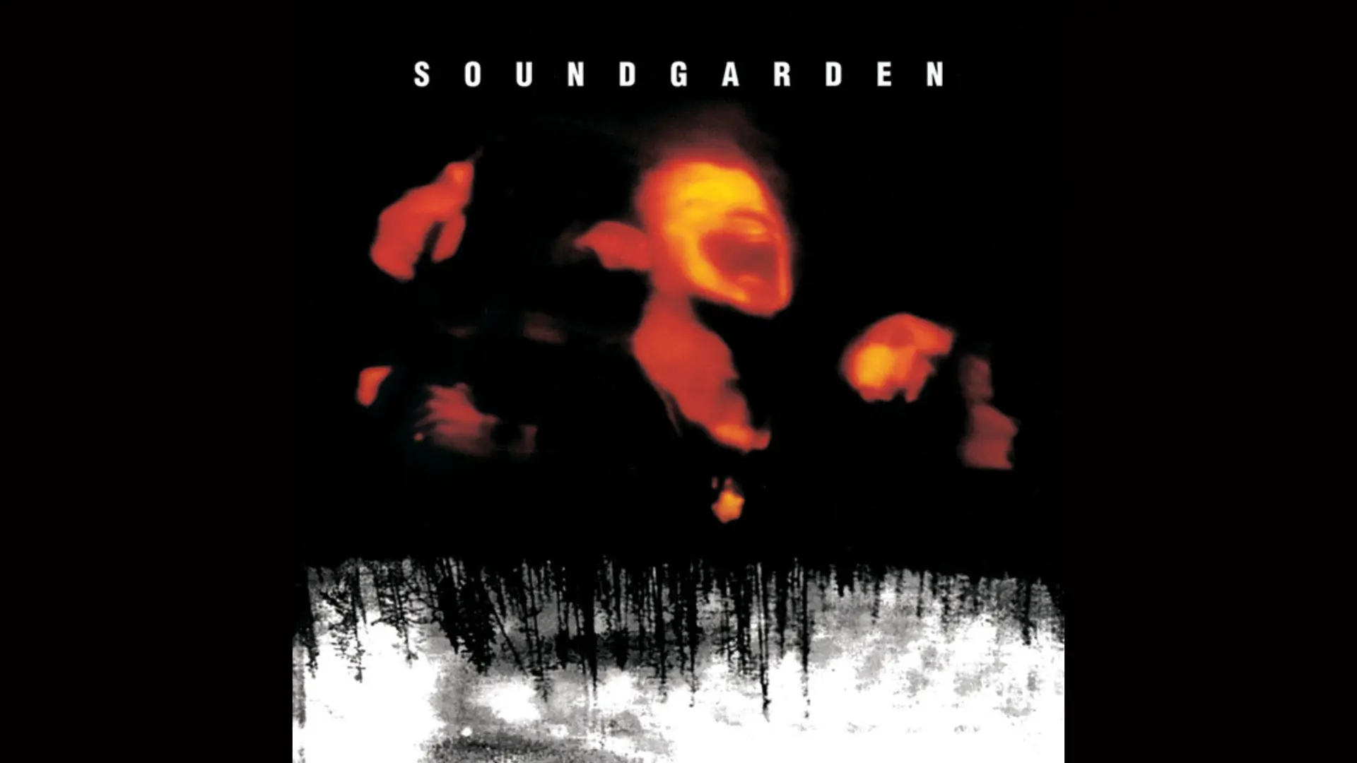 An image of the album cover "Superunknown" by Soundgarden showing a man singing out of focus in oranges and reds with a black background and white diffusion at the bottom with the words SOUNDGARDEN at the top