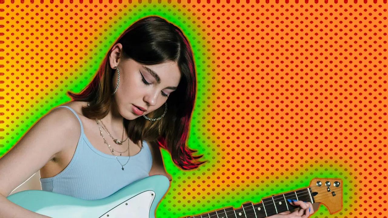 A woman wearing blue playing a blue and white electric guitar against an orange dotted background with a green halo.