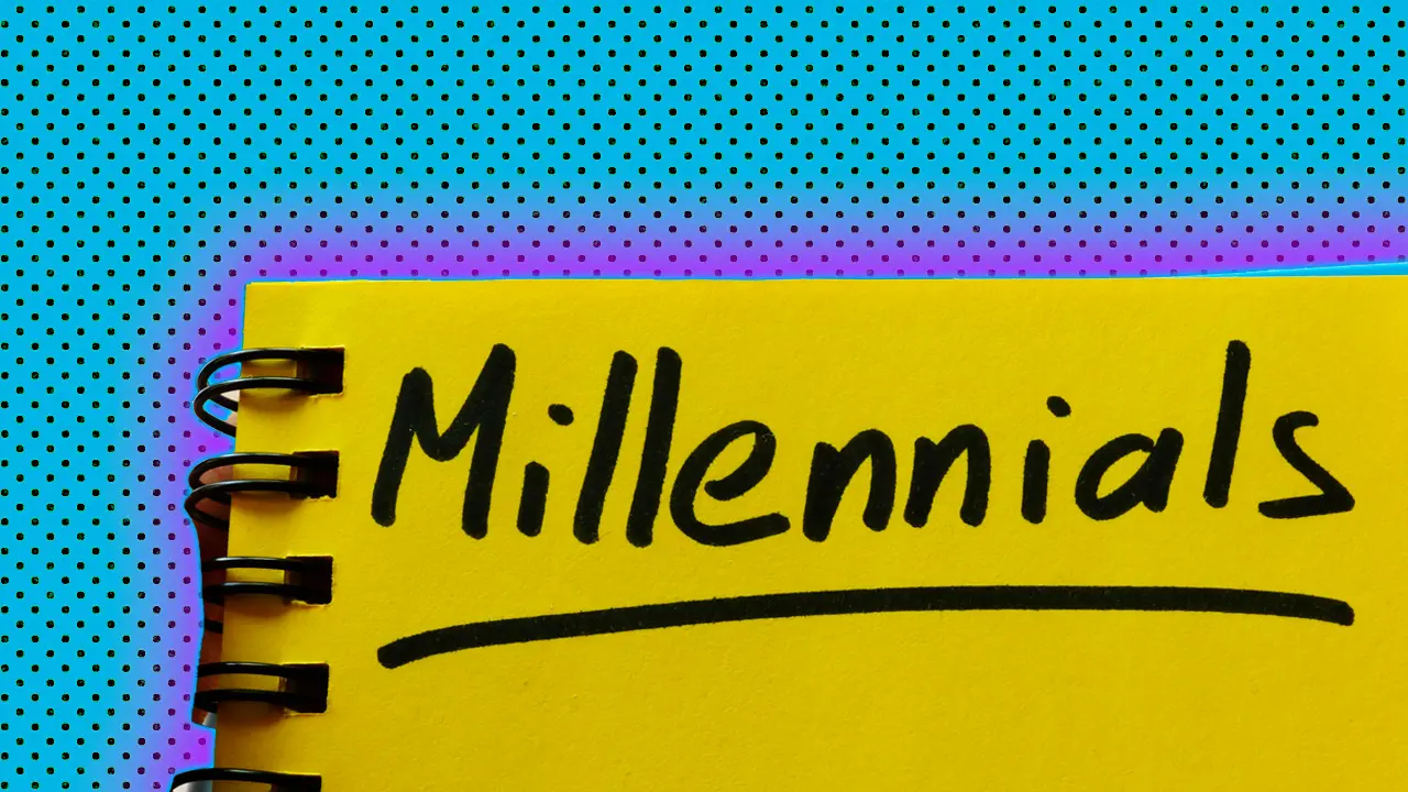 A photo of a yellow notebook that has "Millennials" written in black pen at the top with an underline with a blue dotted background and pink halo.
