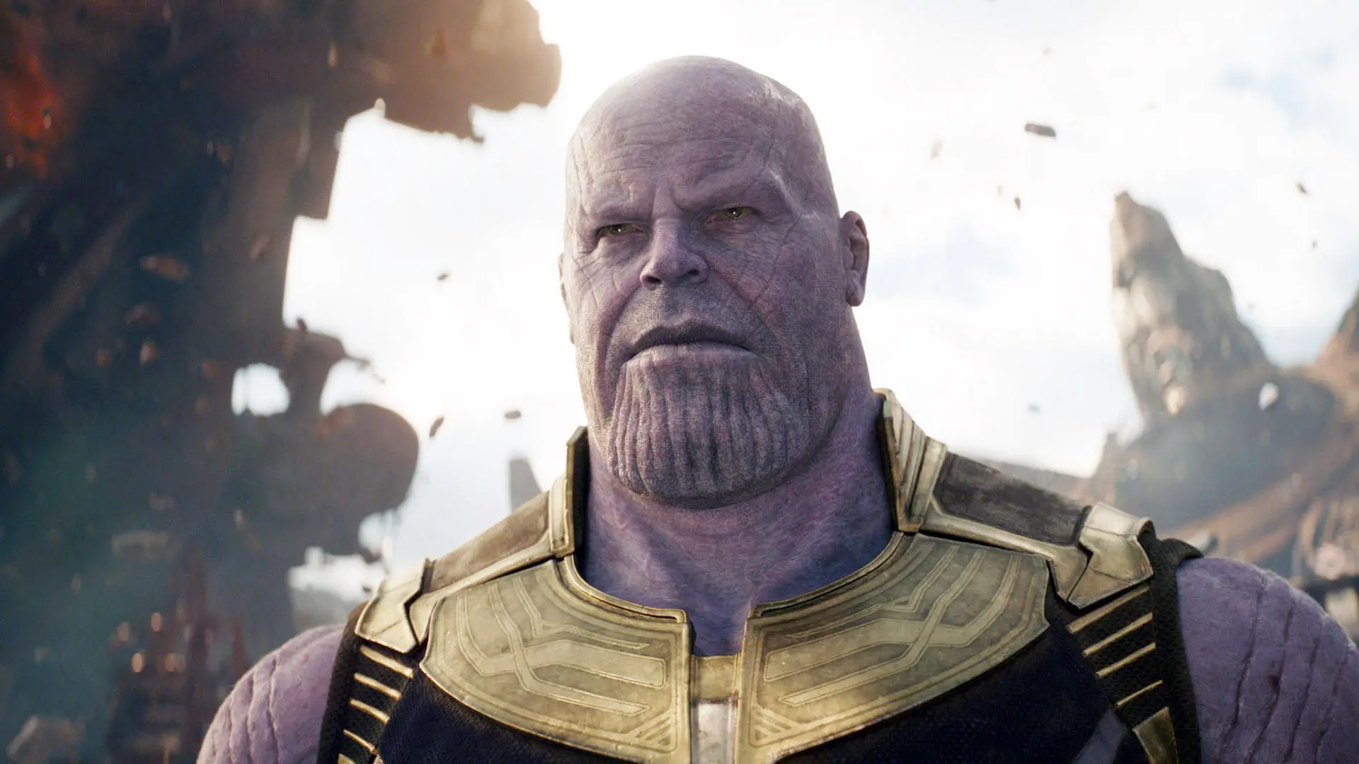 A still from Marvel's Avengers Infinity War showing Thanos stood in front of a folding city scape.
