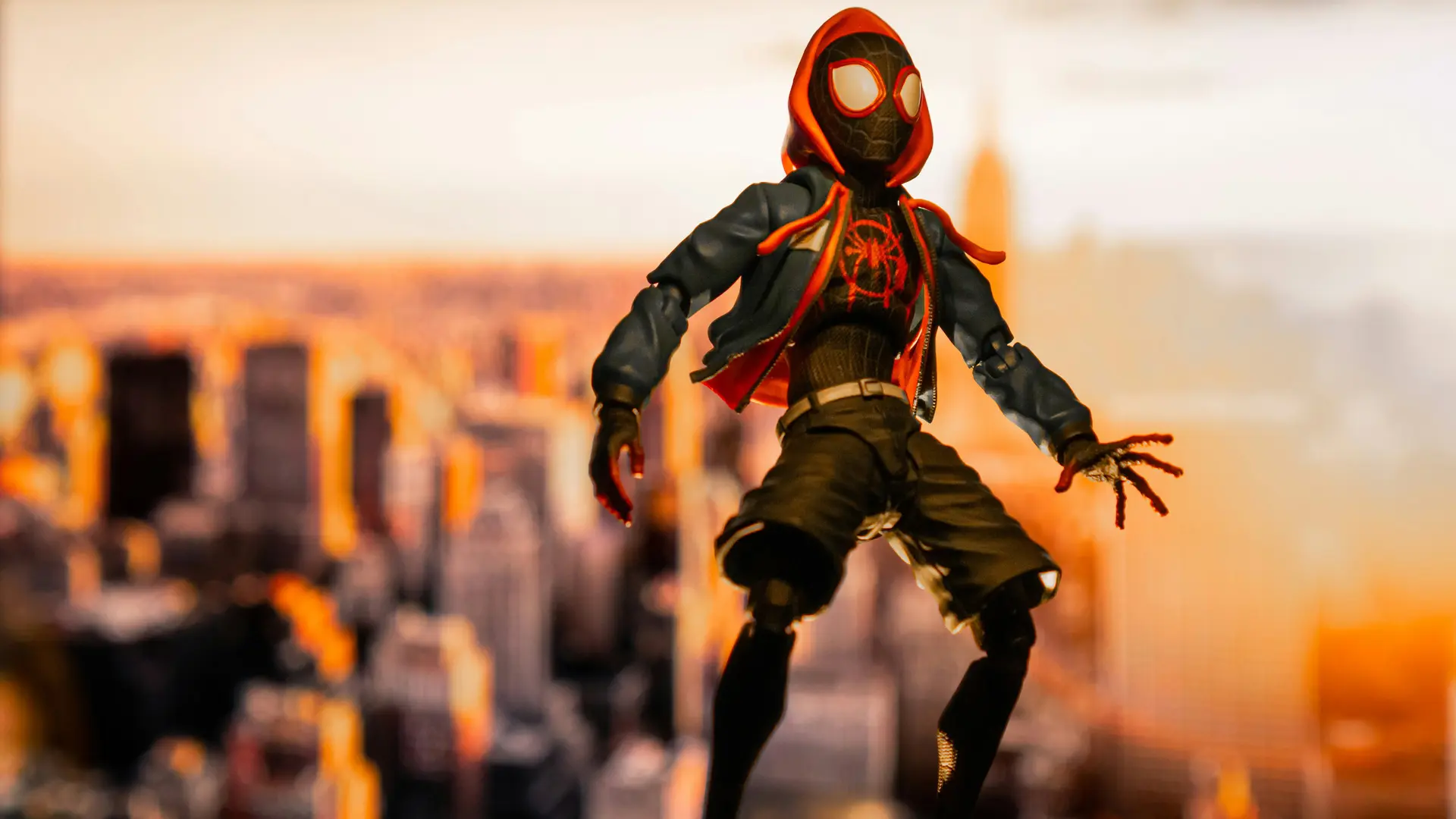 An image of Miles Morales floating above a city skyline at sunset