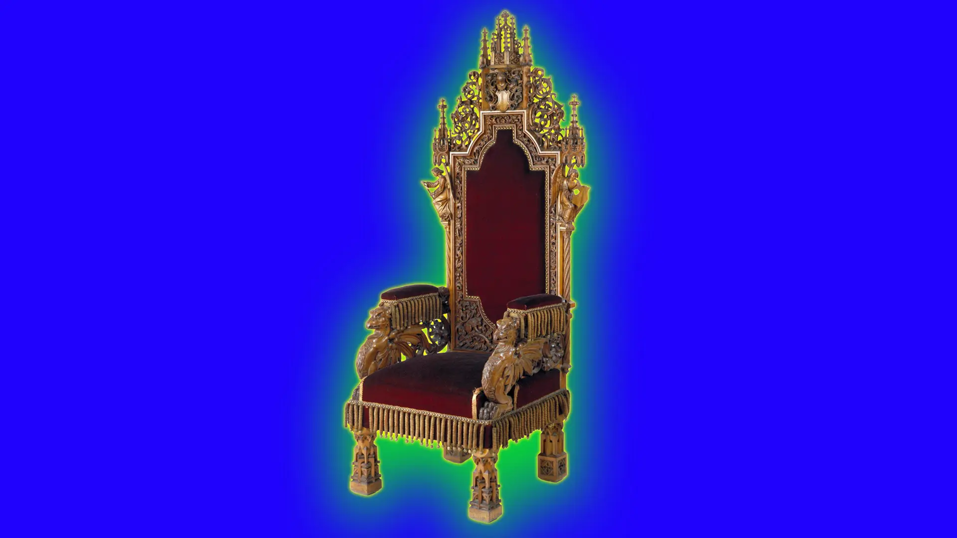 A red and gold 19th century gothic throne set against a royal blue background with a green halo